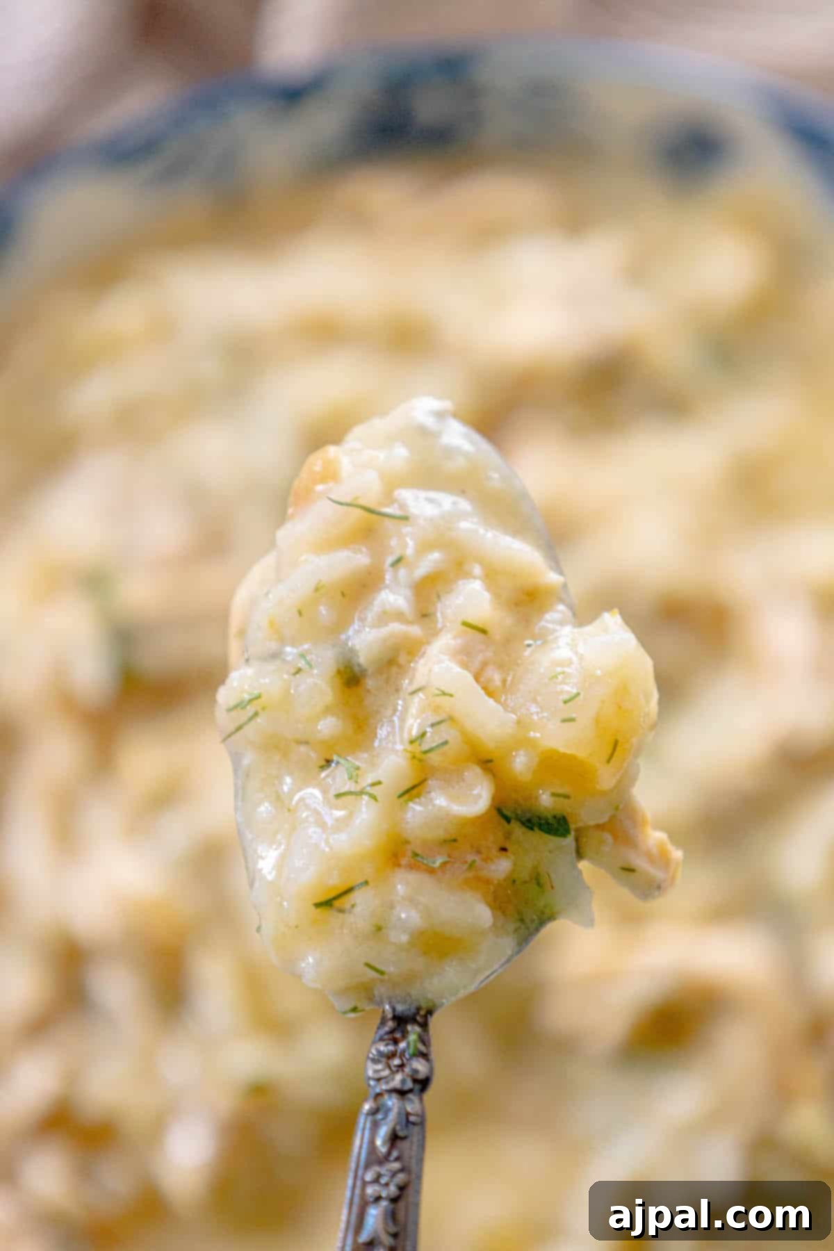 Velvety Greek Avgolemono 7 Greek avgolemono soup on a spoon.