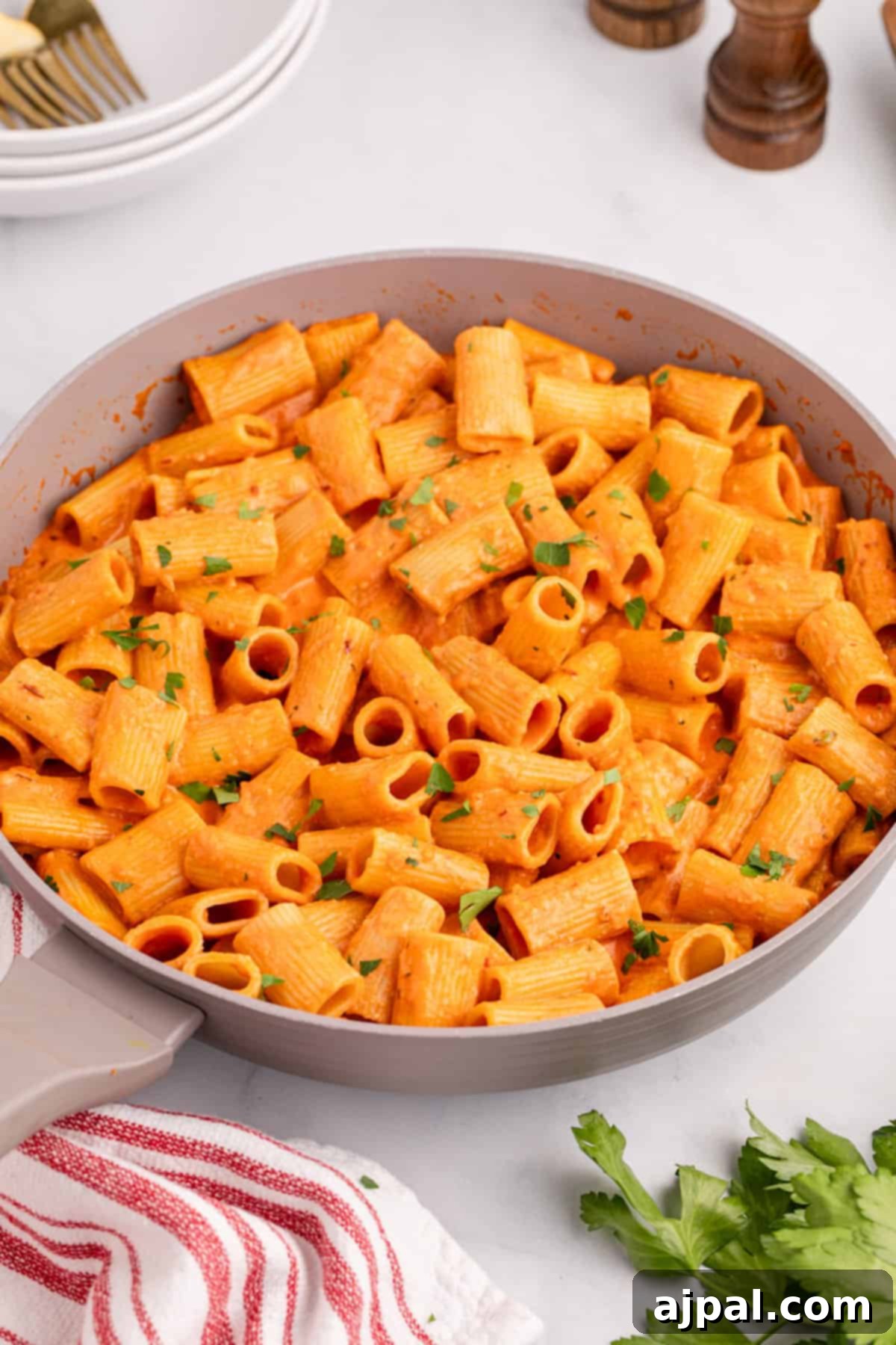 A spicy pan full of rigatoni pasta in a red sauce, ready to be served.