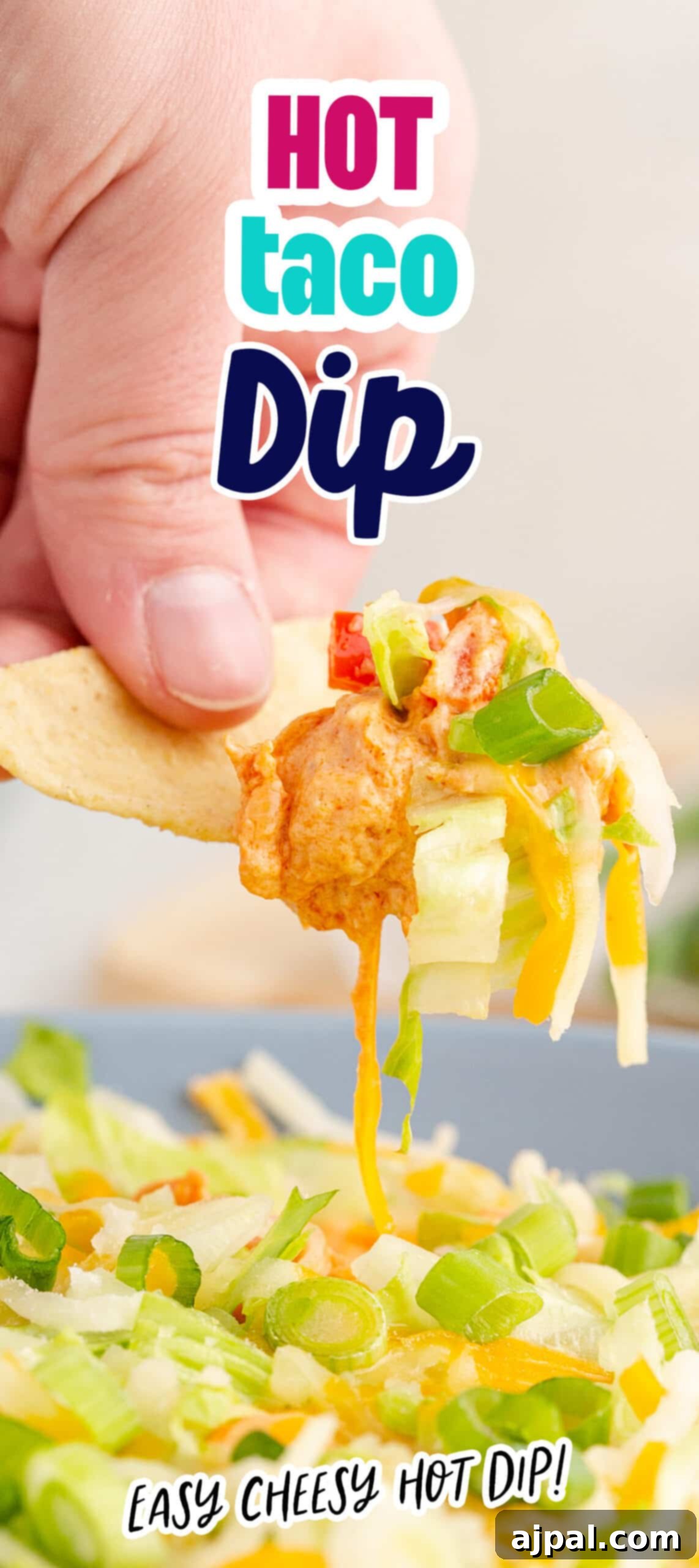 Zesty Taco Dip 12 A stunning vertical shot of hot taco dip, perfectly cheesy and topped with fresh ingredients, ready for dipping.