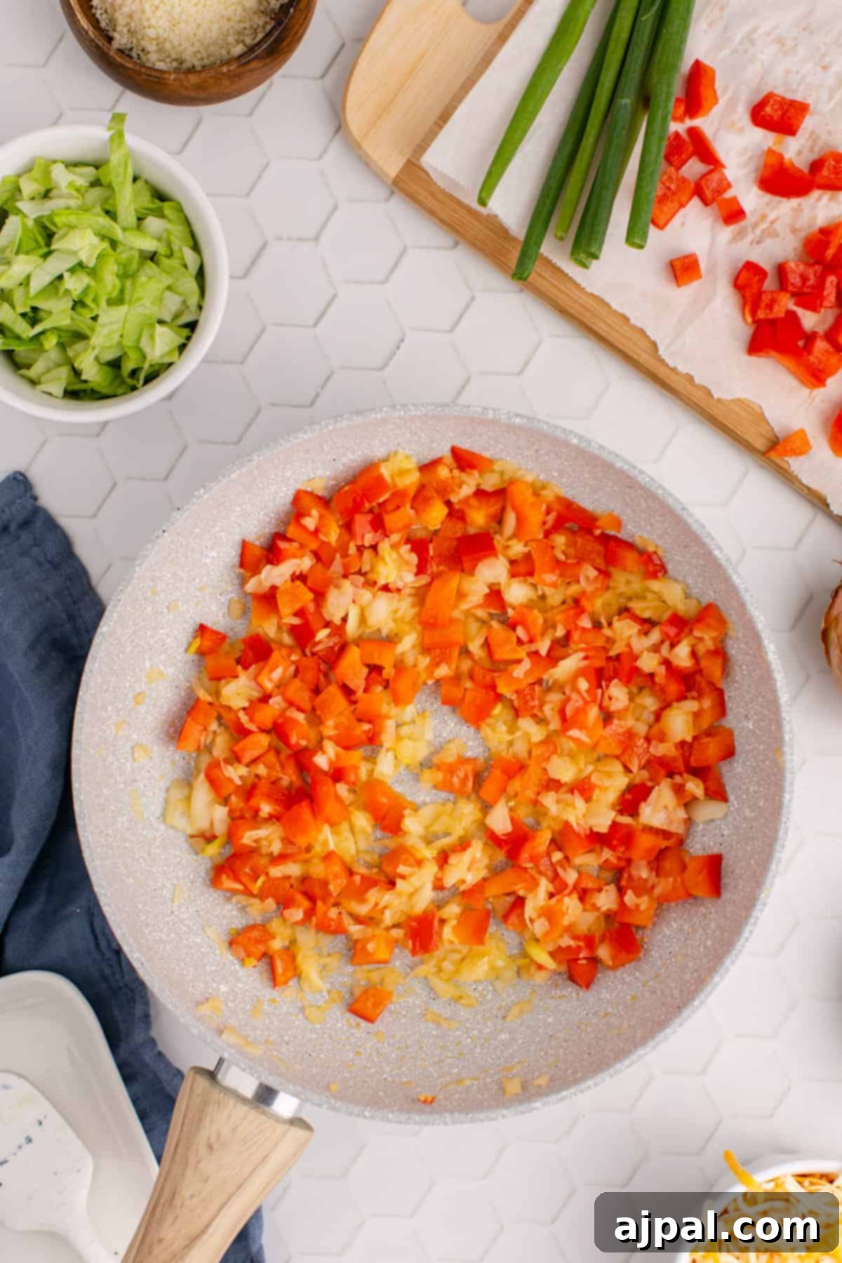 Zesty Taco Dip 7 A hot frying pan with a colorful mix of peppers, onions, and sauce, ready for the cheese.