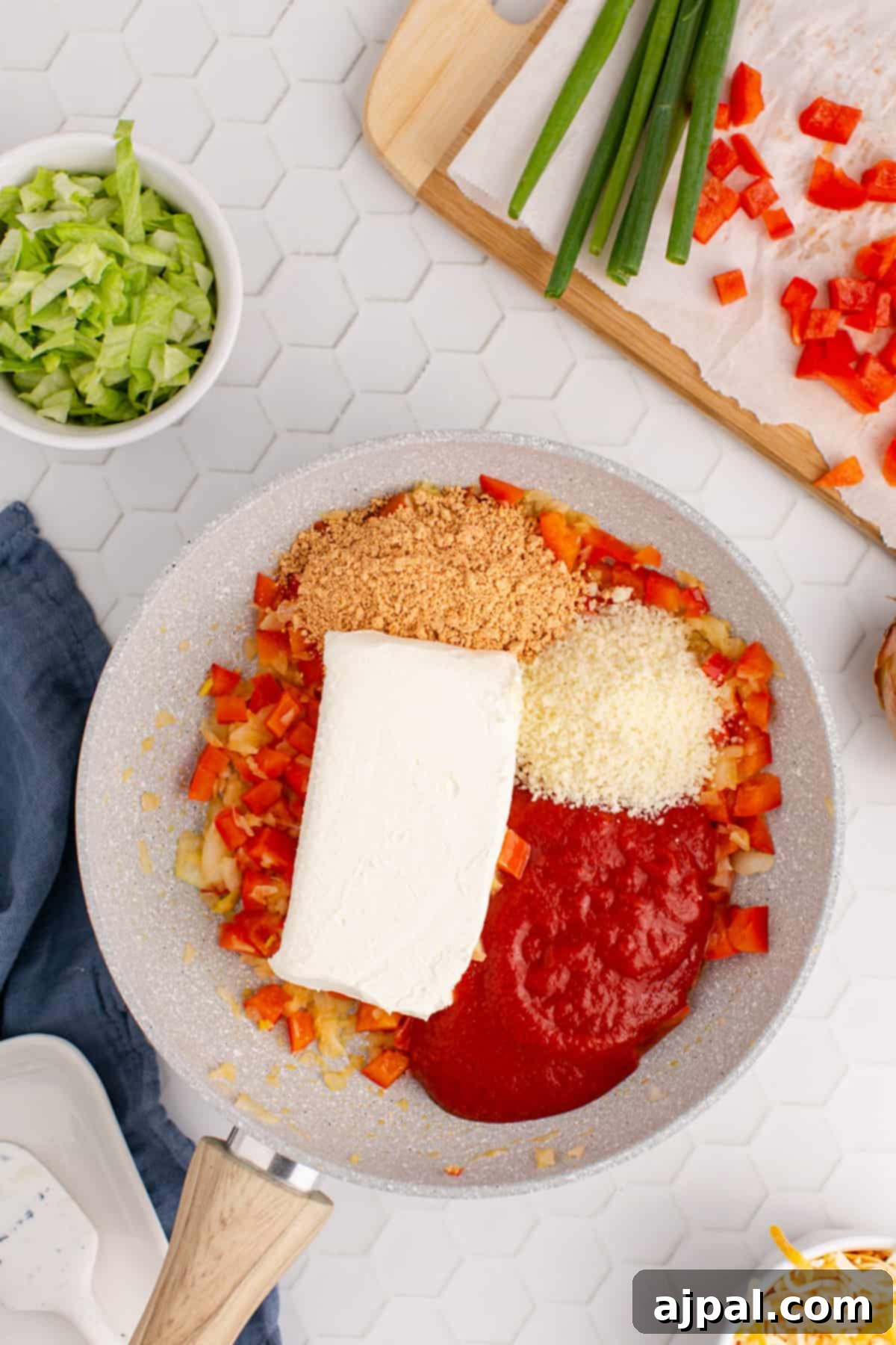 Zesty Taco Dip 8 A sizzling frying pan containing a rich, creamy taco dip mixture, just before serving.