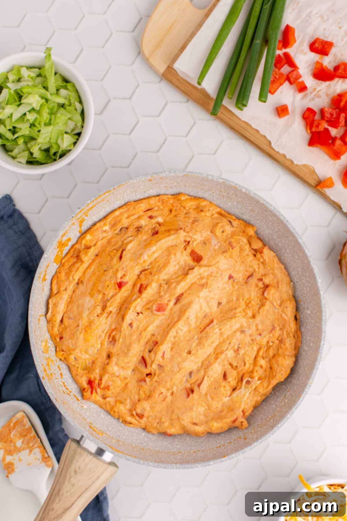 Zesty Taco Dip 9 Hot, bubbling taco dip in a skillet, fresh from the oven, ready to be garnished.
