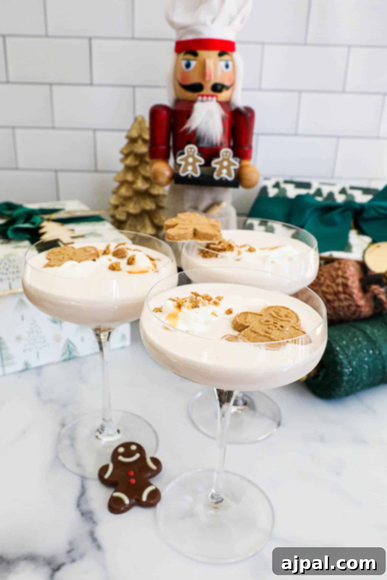 Gingerbread Spice Martini 3 Gingerbread martini with whipped cream and gingerbread cookies. A close-up view of a festive holiday cocktail.