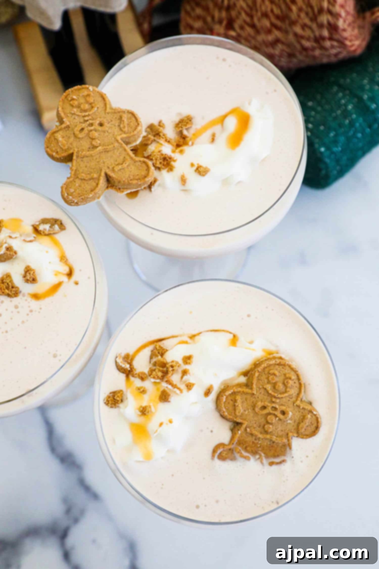 Gingerbread Spice Martini 5 Indulge in a delightful gingerbread martini garnished with a dollop of whipped cream and accompanied by delectable gingerbread cookies.