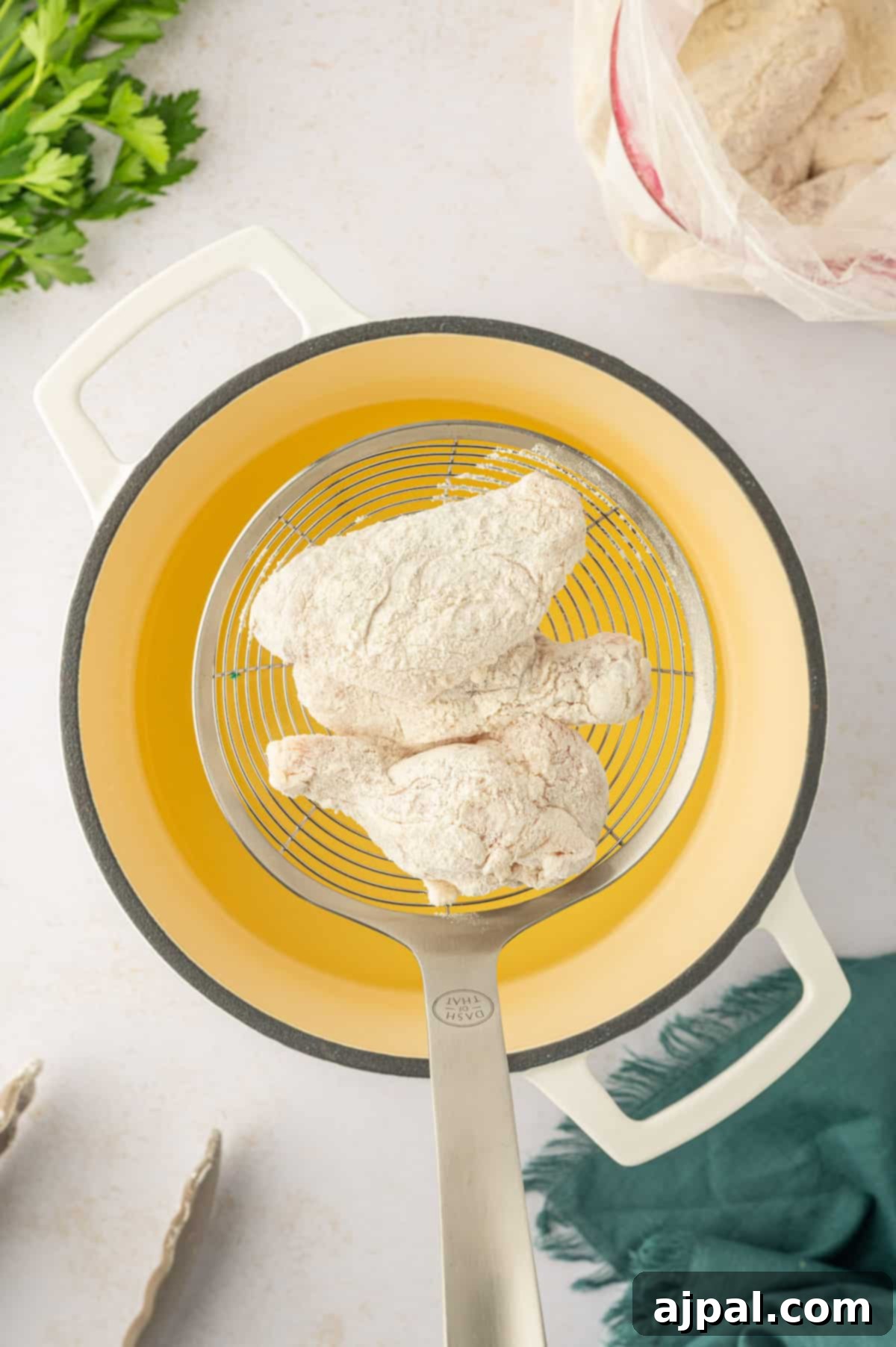 Golden-brown lemon pepper chicken wings sizzling in a deep frying pan.