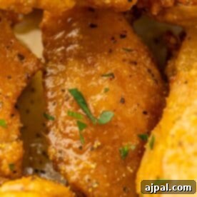 A mouthwatering close up of perfectly cooked lemon pepper chicken wings, golden and crispy.