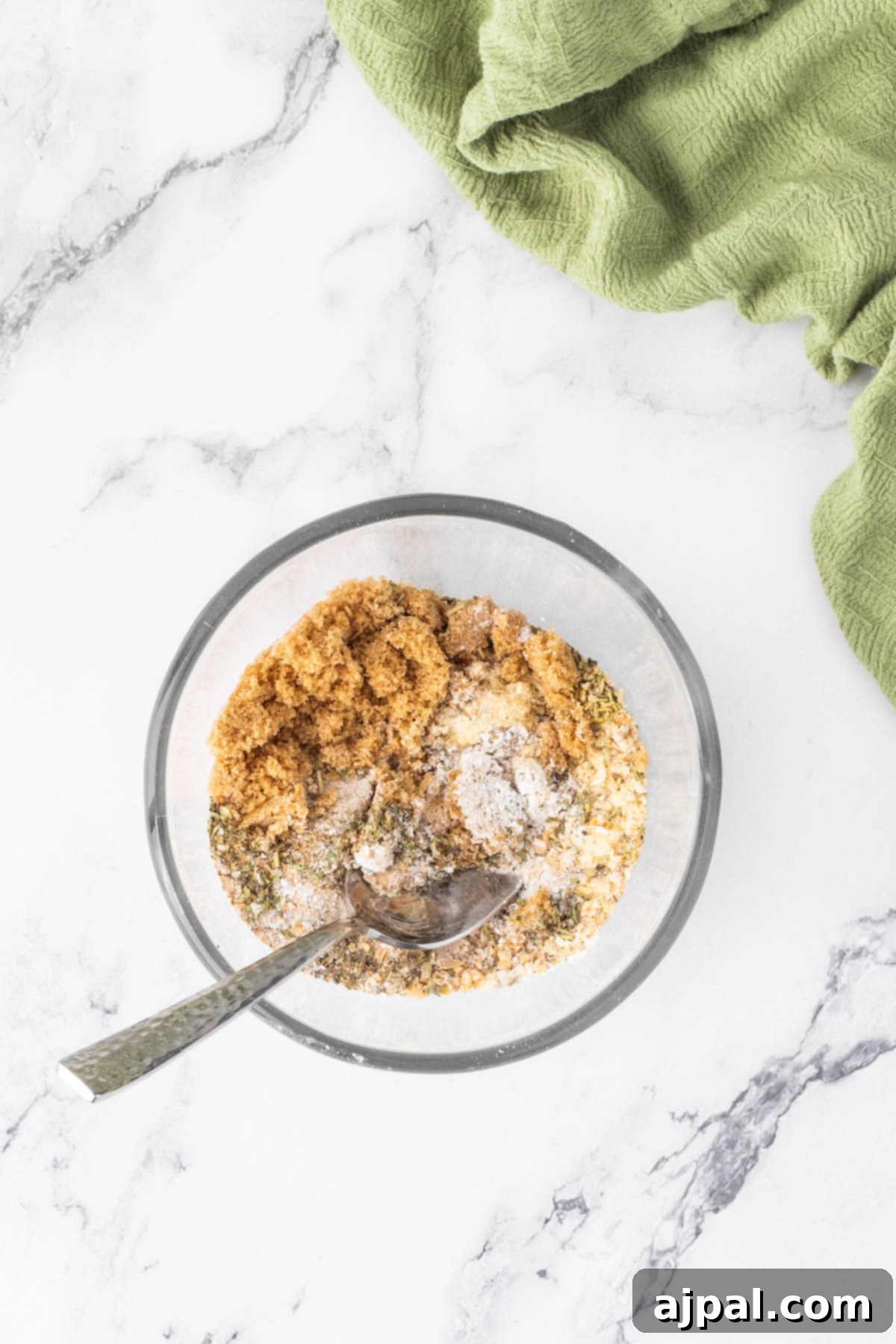 Crispy Air-Fried Wings 6 A bowl of oatmeal with a spoon on a marble table, next to an air fryer, illustrating ingredients preparation.