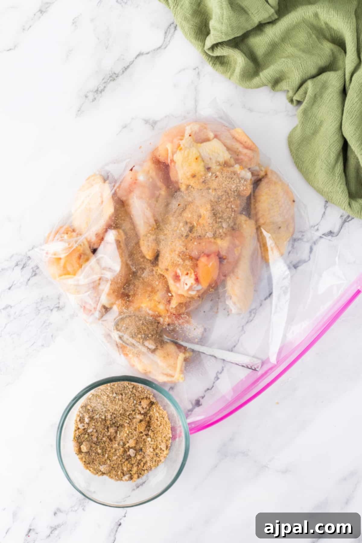 Crispy Air-Fried Wings 8 A bag of chicken wings in a plastic bag next to a spoon, emphasizing raw ingredients.