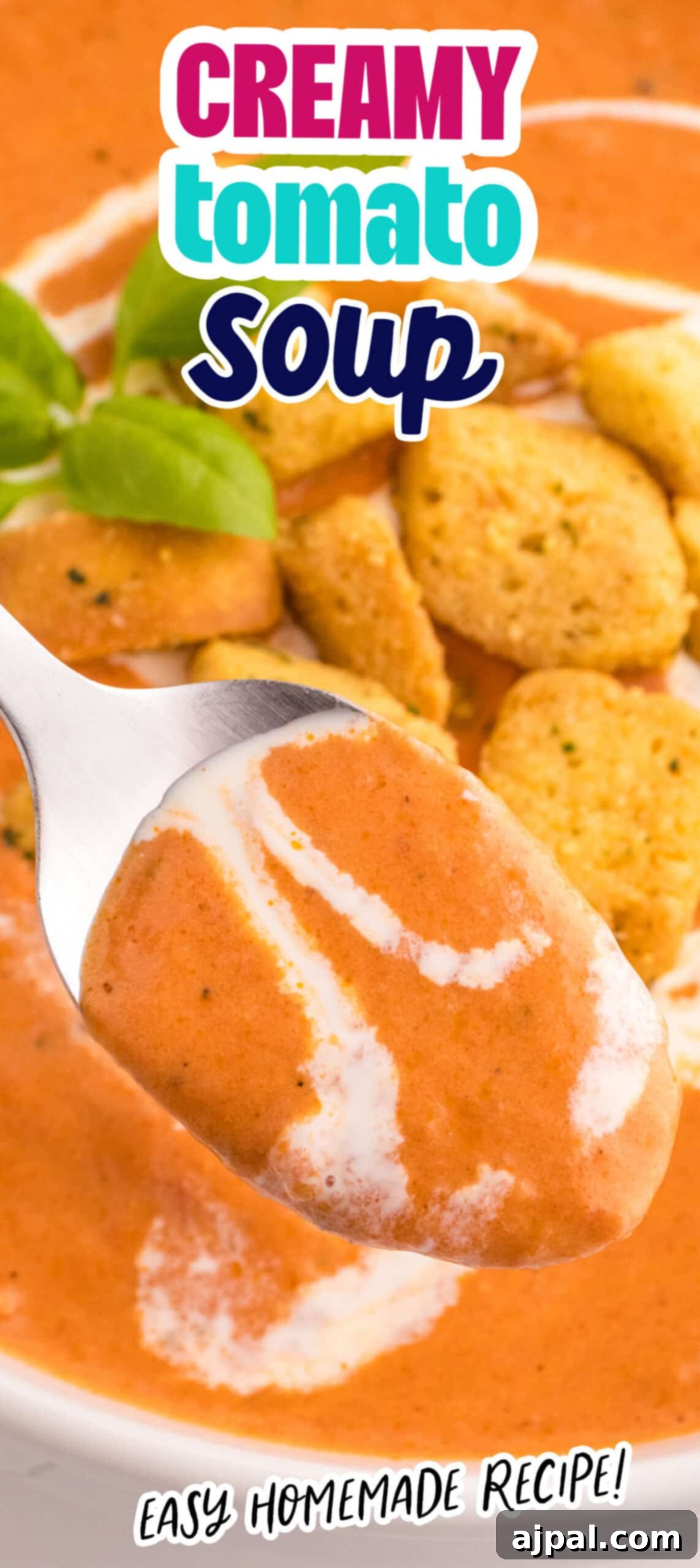 A bowl of creamy tomato soup served with a spoon, highlighting its rich texture and inviting appearance.