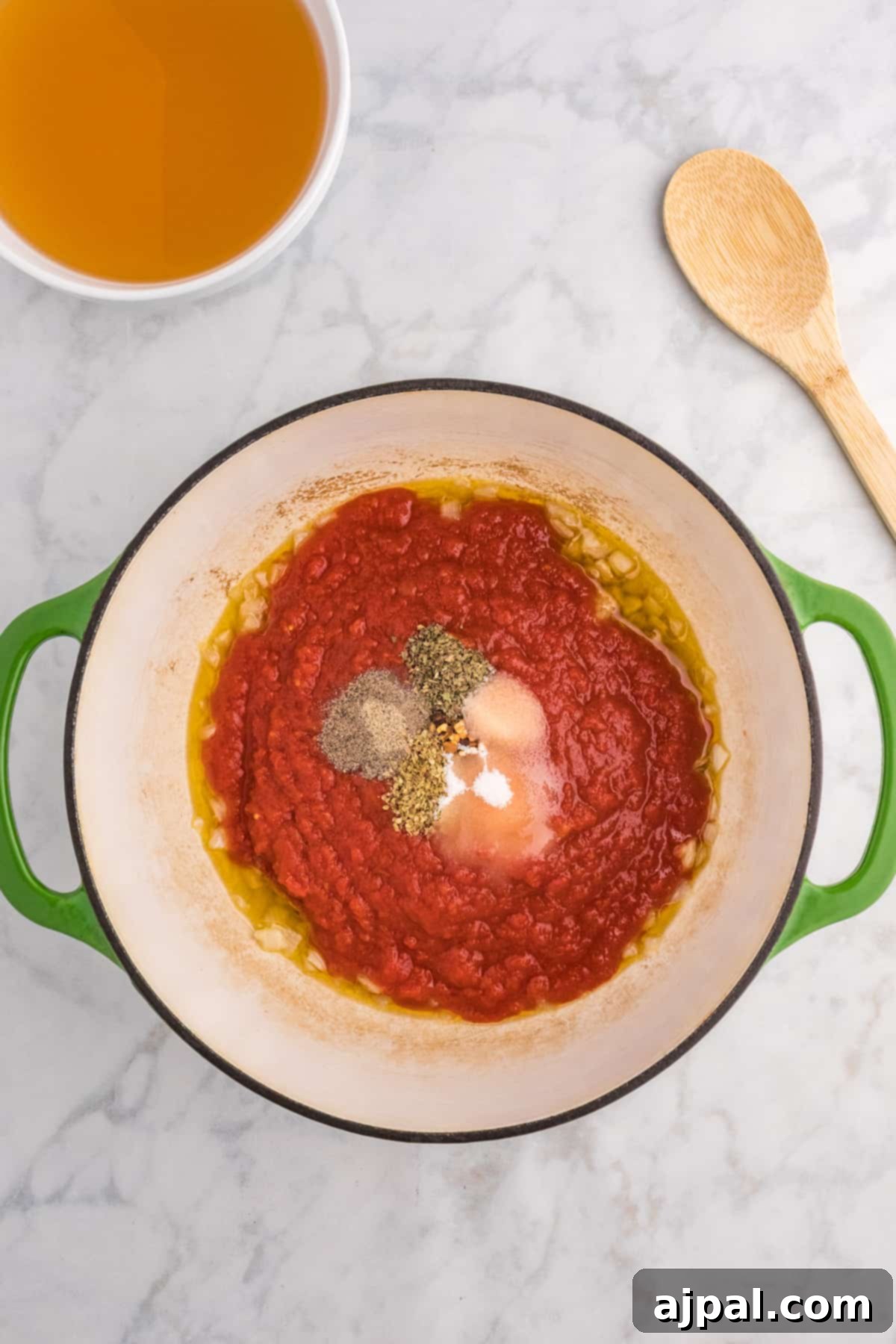 A rich, red sauce simmering in a pot on the stove, soon to become creamy soup.