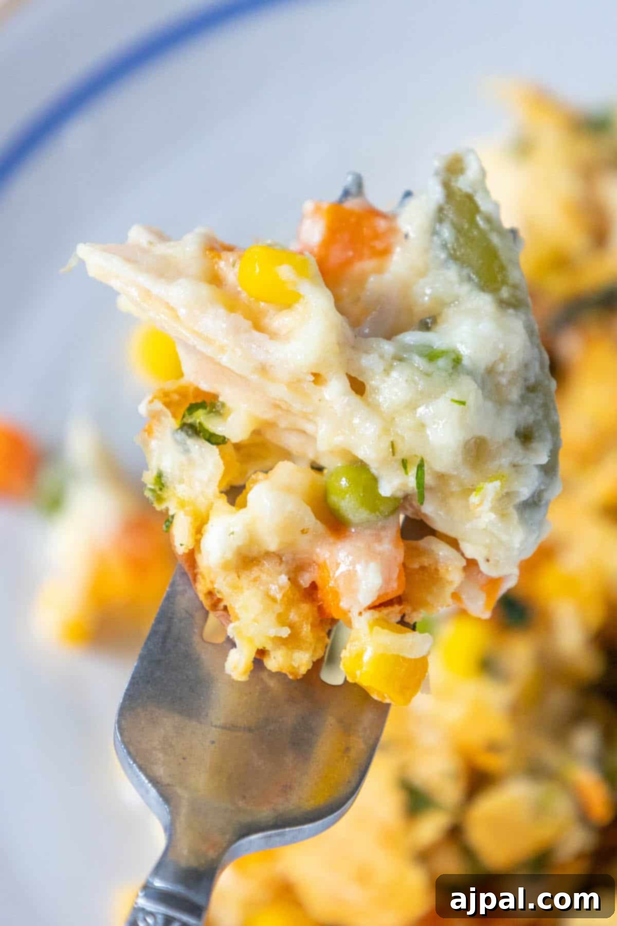 A creamy forkful of chicken and vegetable casserole.