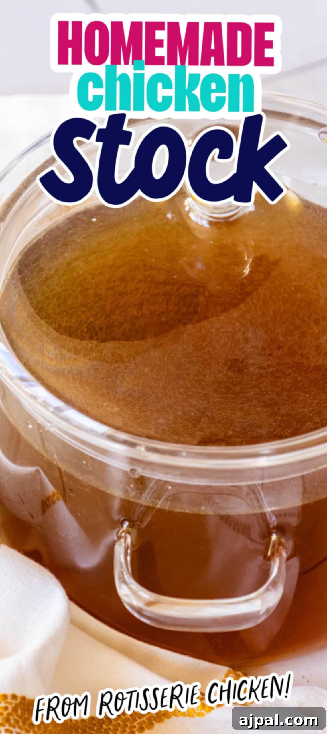 A tall, slender glass bowl showcases perfectly clear homemade chicken stock, ready for culinary use.