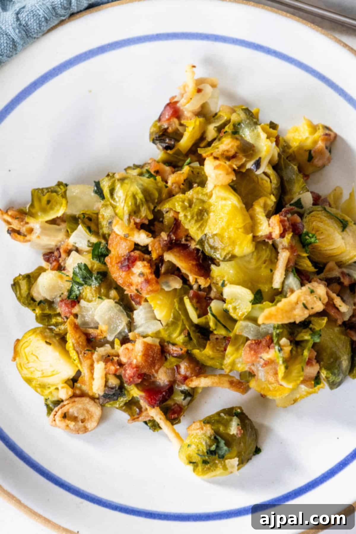 Creamy Brussels sprouts and bacon on a plate, showcasing the rich texture and delicious toppings.