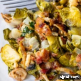 Creamy Brussels Sprouts with Bacon, served with a fork.