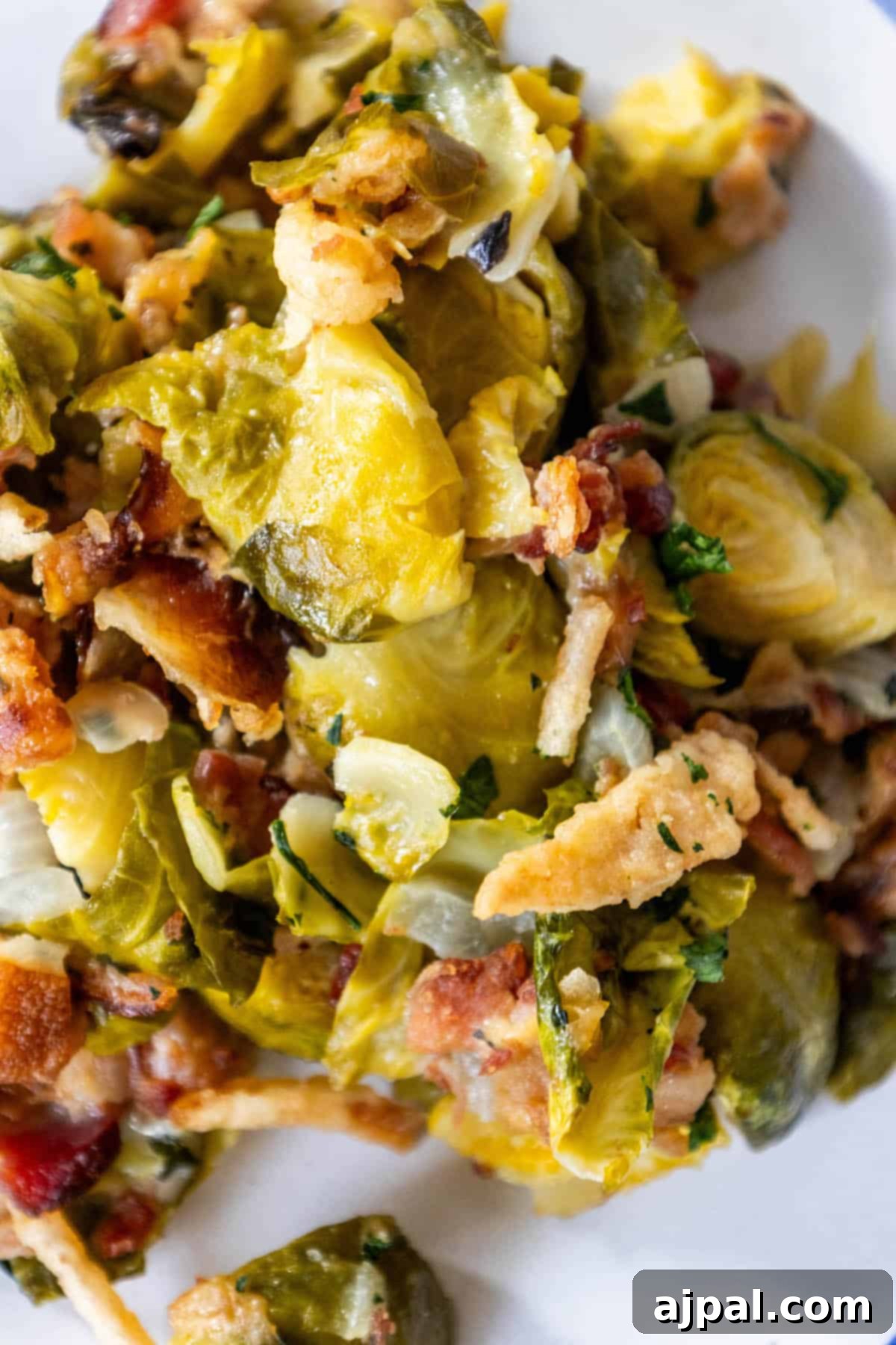 Bacon Brussels Bliss 3 A close-up of a plate filled with creamy Brussels sprouts and bacon, showcasing the delicious texture.