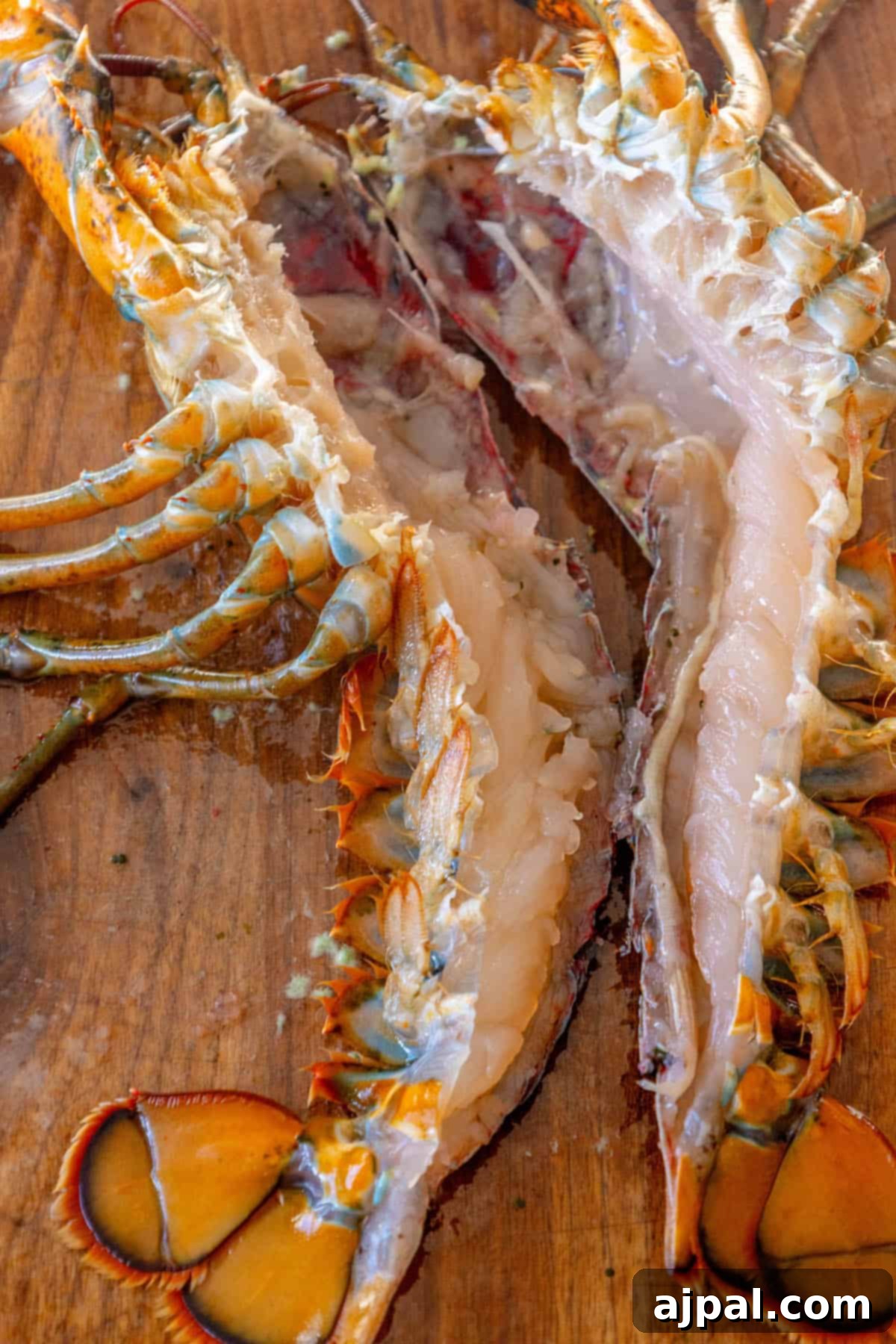 Exquisite Italian Lobster Pasta 8 A Venetian lobster is sitting on a wooden cutting board, ready to be prepared as a delicious Busara Pasta.