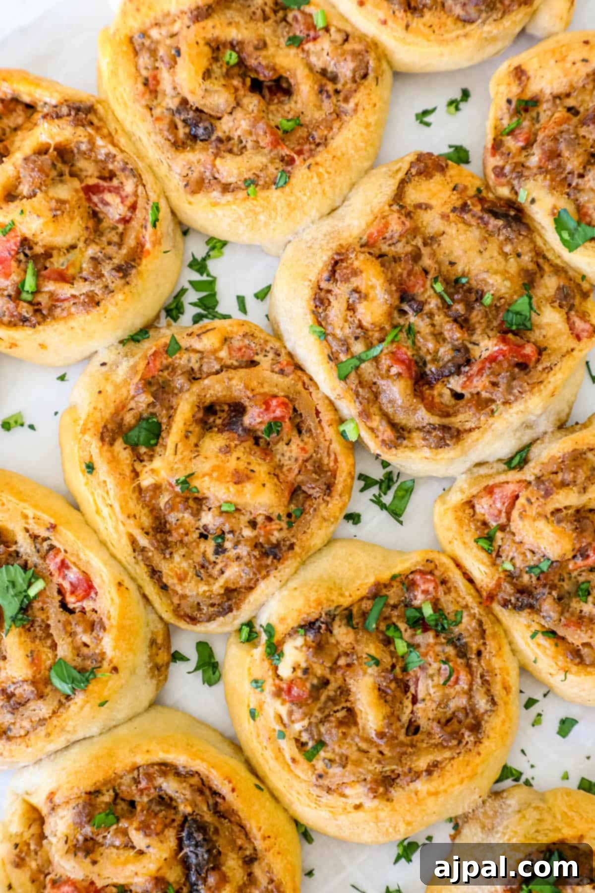 Close-up of baked sausage and cream cheese crescent rolls, showcasing their flaky texture.