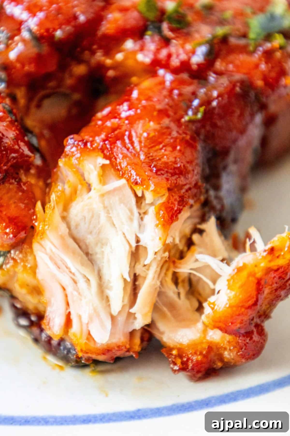A close up of tender, baked boneless country-style pork ribs on a plate.