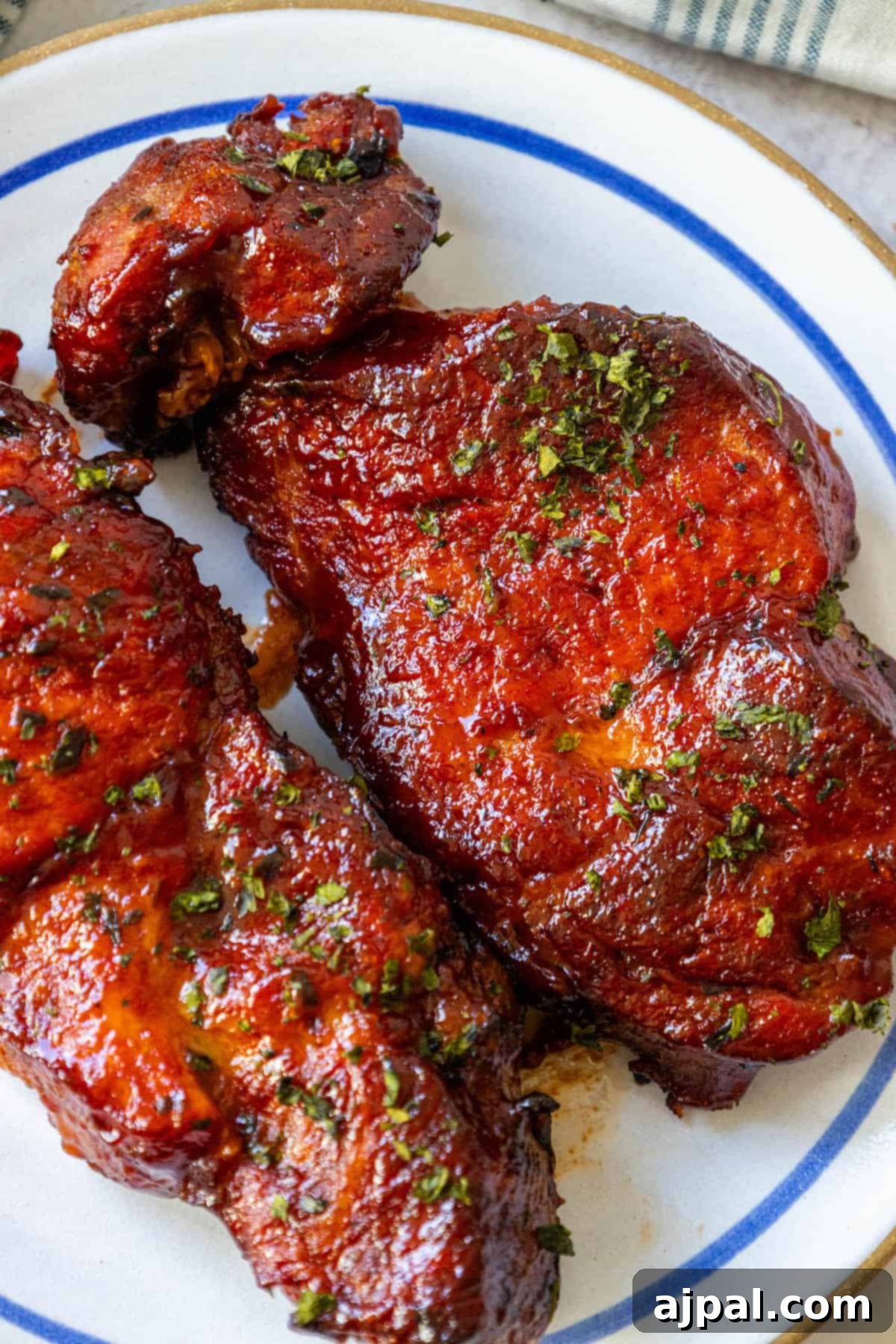 Baked BBQ boneless country-style ribs on a blue and white plate.