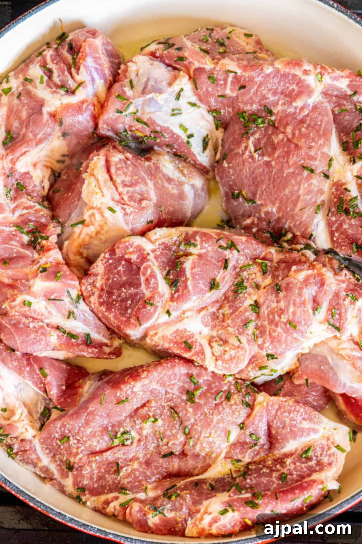 A table showcasing a pan of baked BBQ boneless country style ribs.