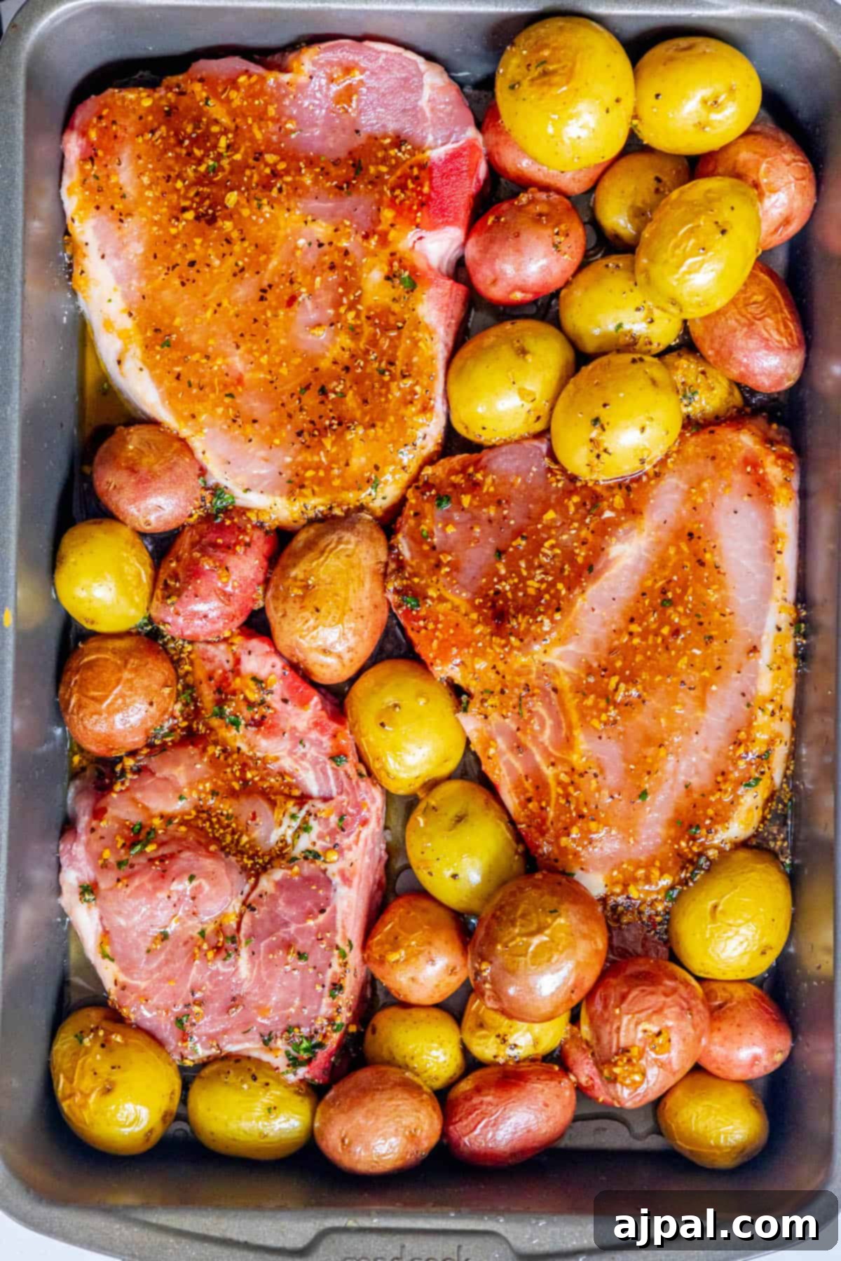 Hearty Pork Chops and Roasted Potatoes 5 Pork Chops and Potatoes: A savory combination in a baking pan, ready for the oven.