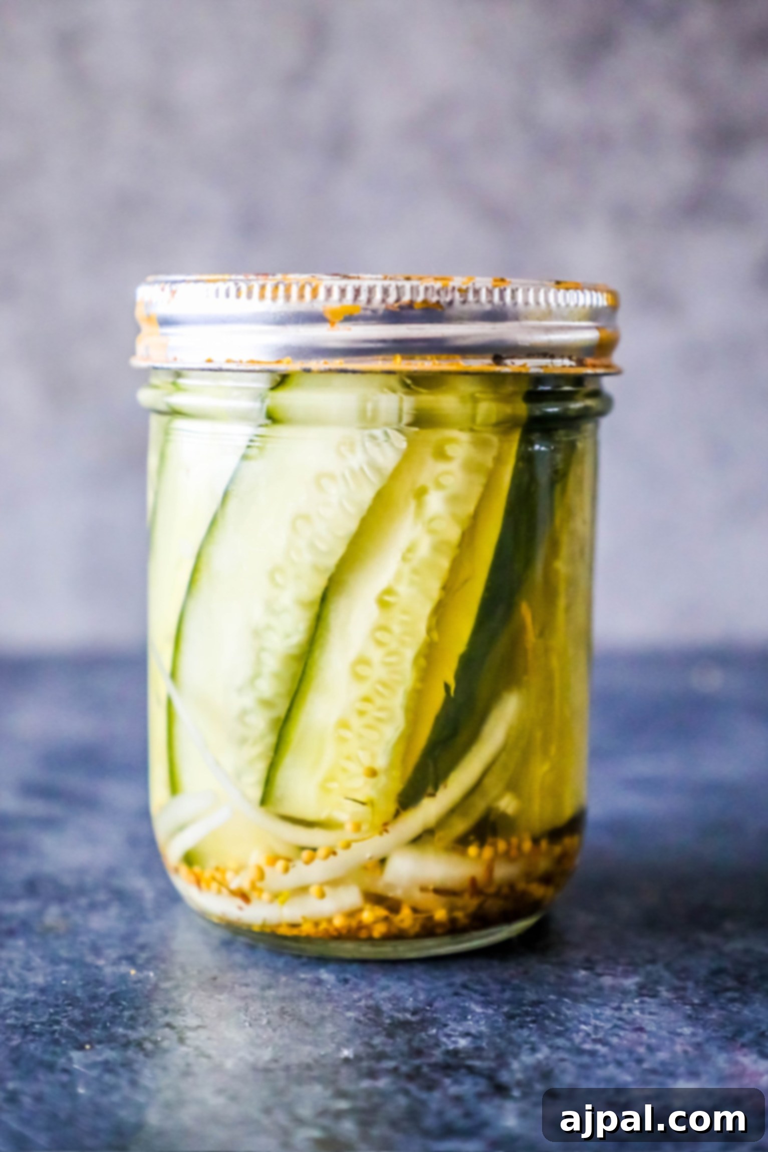 Quick Chill Pickles 3 A glass jar of freshly made refrigerator pickles, gleaming on a kitchen counter, showcasing the simplicity of this 10-minute recipe.