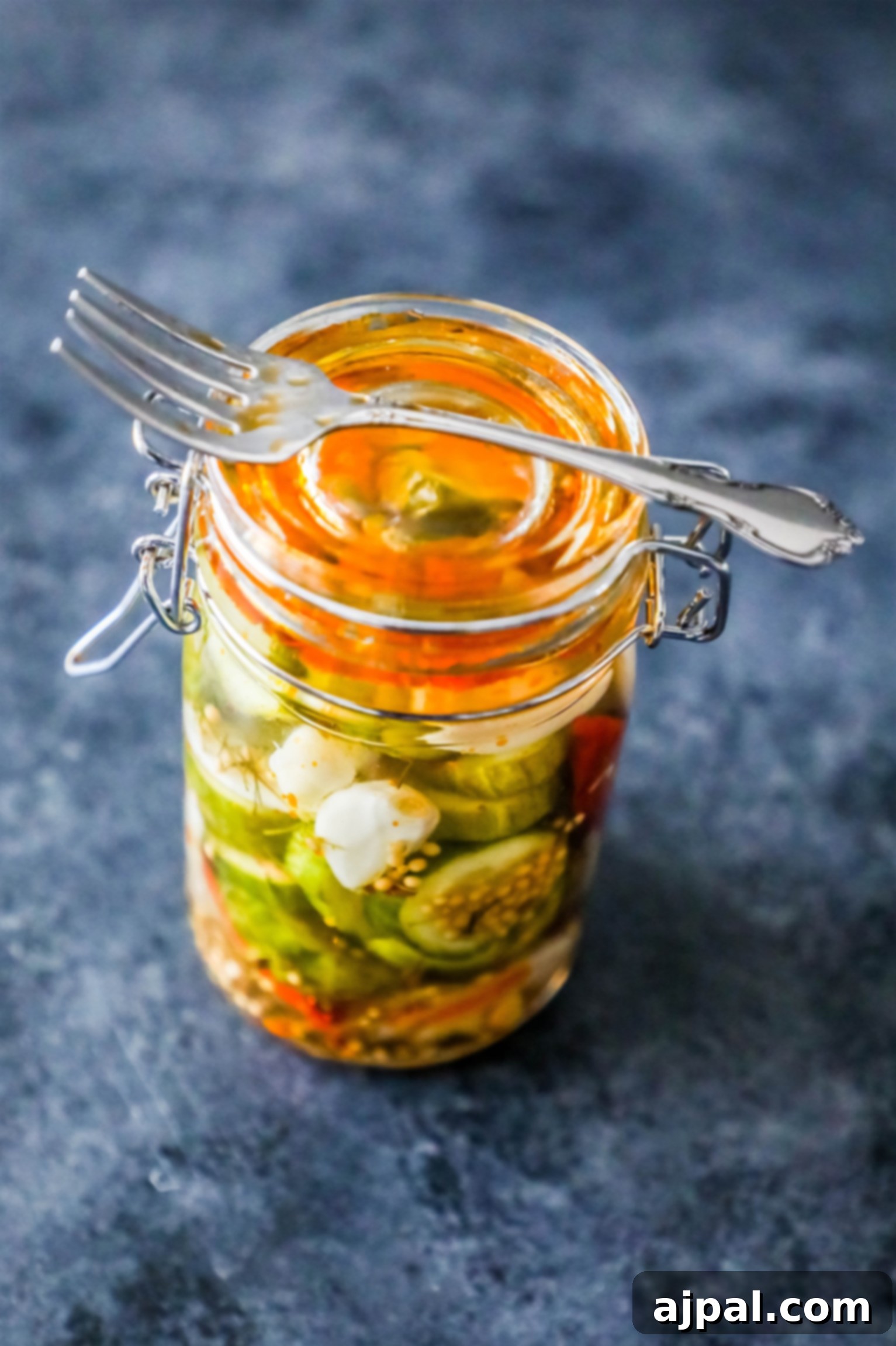 Quick Chill Pickles 5 A jar of freshly prepared quick refrigerator pickles, showing a mix of cucumber slices and spices, ready to chill for 10 minutes.