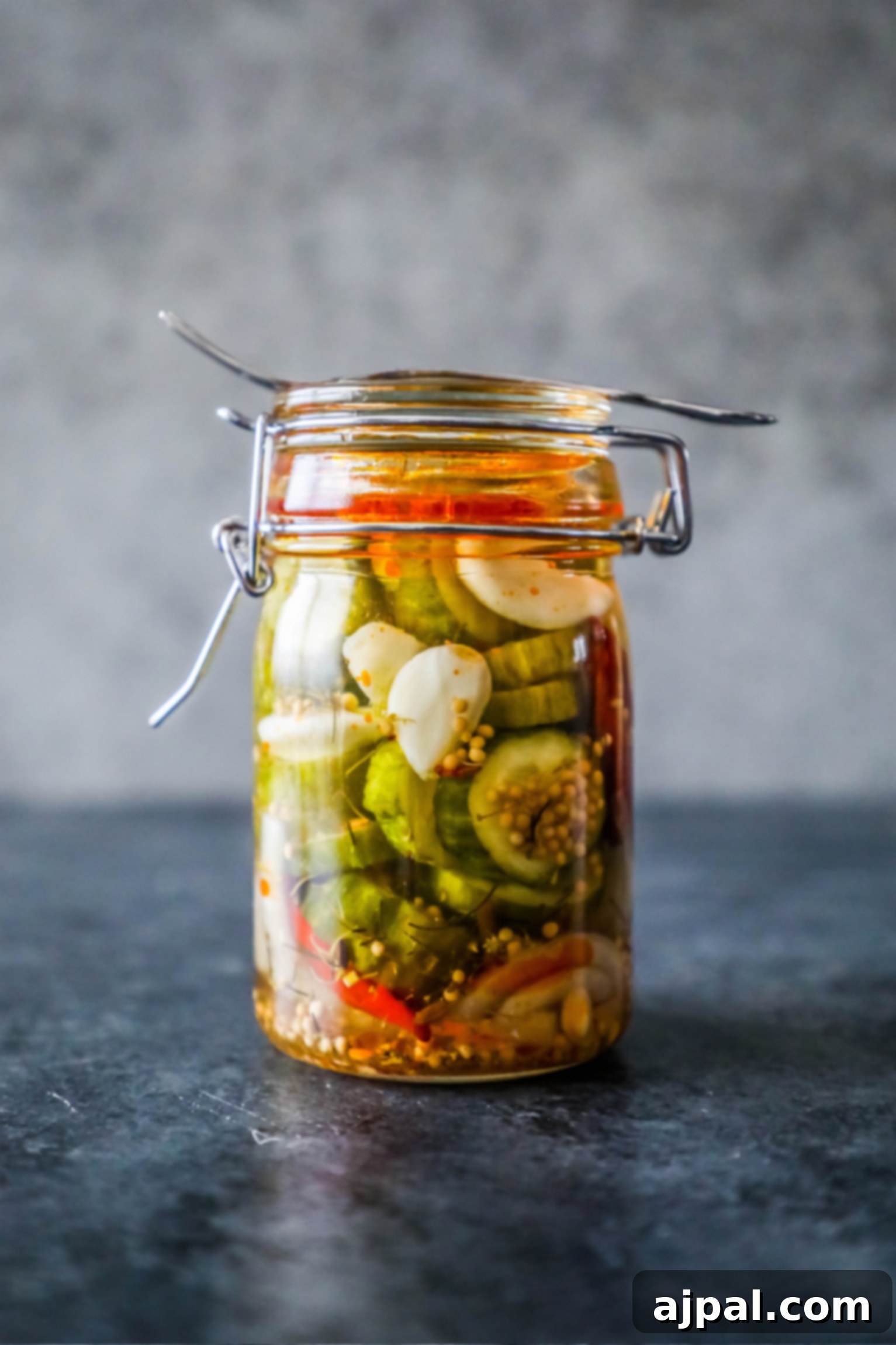 Quick Chill Pickles 4 A glass jar filled with mixed quick pickles, including spears and chips, on a table, highlighting the versatility of the recipe.
