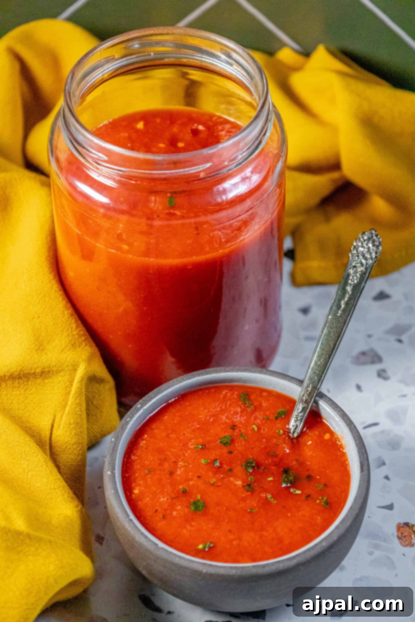 Classic Margherita Pizza Sauce 2 A jar of vibrant red Margherita tomato sauce with a wooden spoon resting beside it, inviting you to taste its freshness.