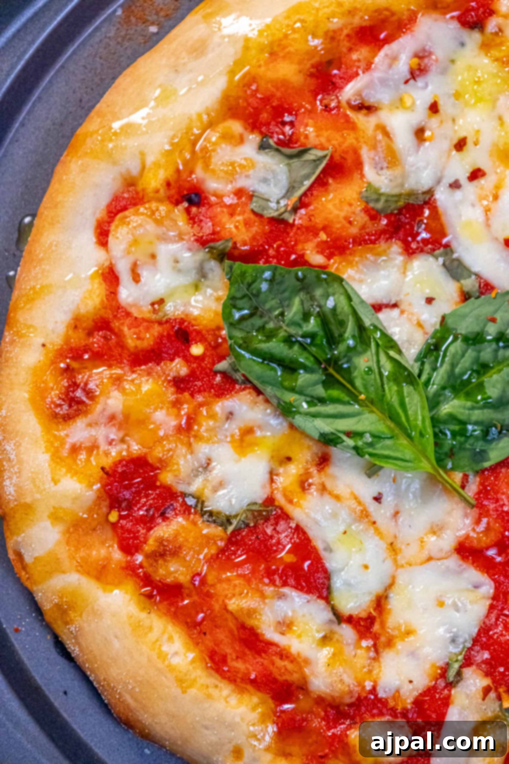 Authentic Margherita Pizza Made with Homemade Sauce A freshly baked Margherita pizza adorned with basil leaves and rich tomato sauce, ready to be served.