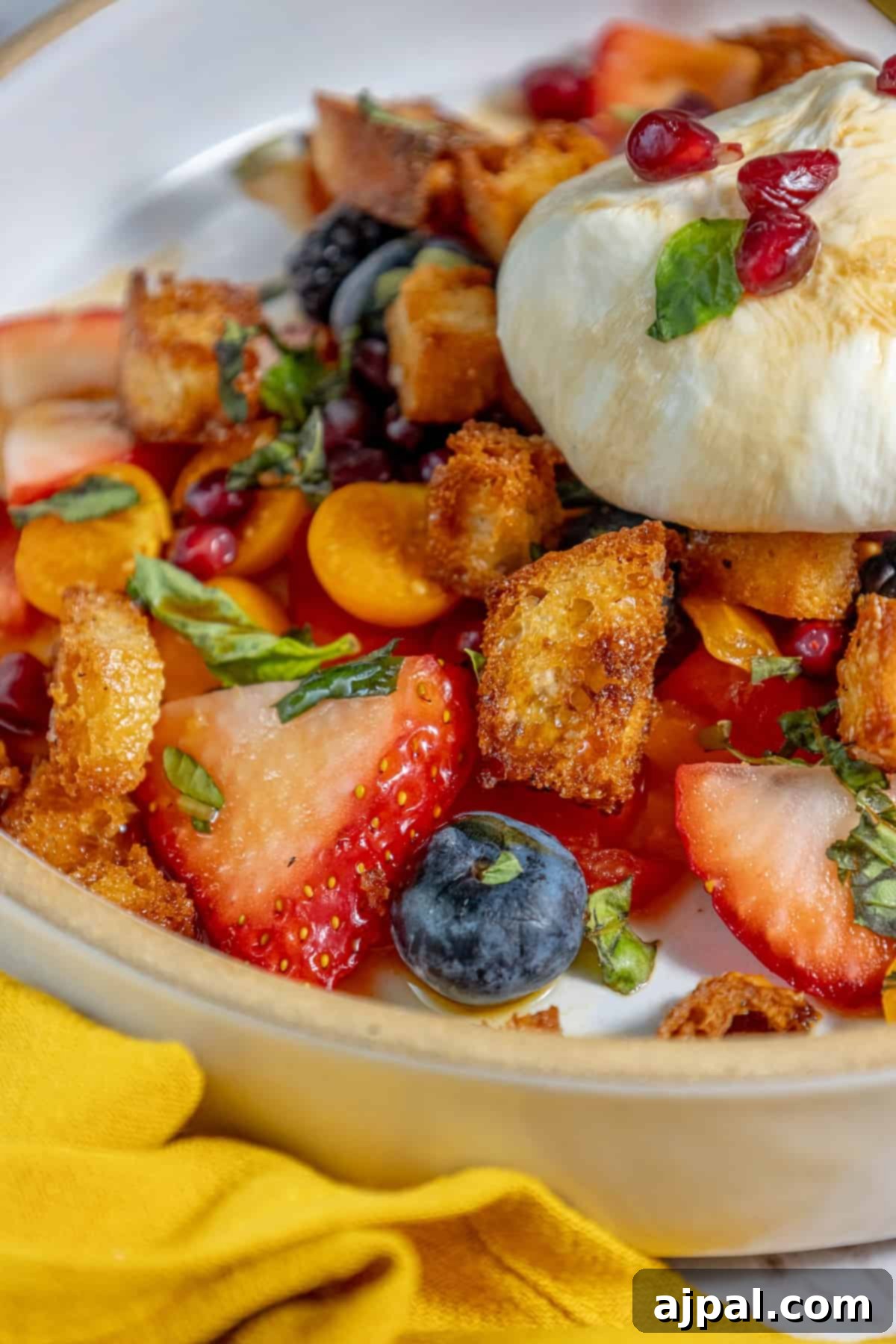 Summer Berry Burrata Medley 13 A delightful plate adorned with a colorful array of fresh berries, ready to be enjoyed.