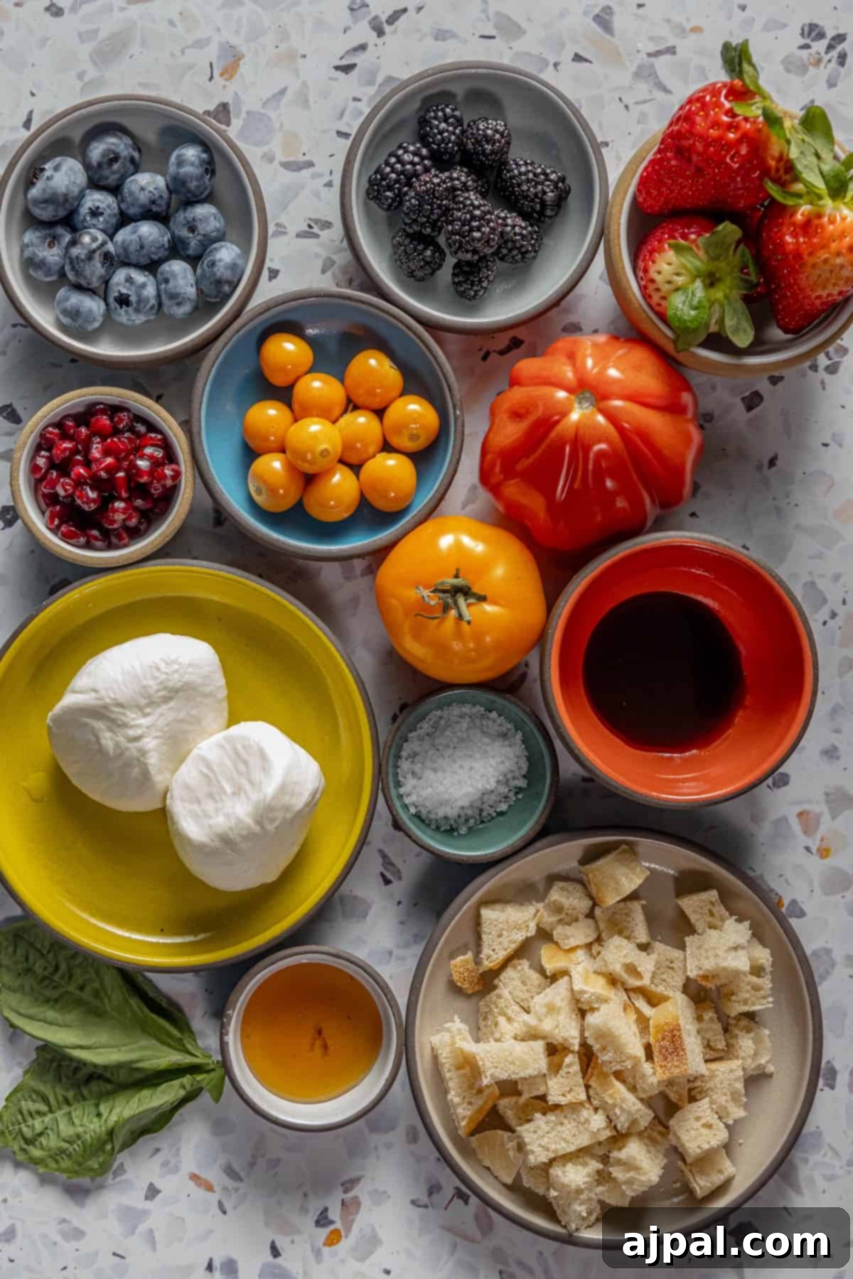 Summer Berry Burrata Medley 3 A colorful array of fresh fruits, vegetables, and berries spread across a rustic wooden table, ready for salad preparation.