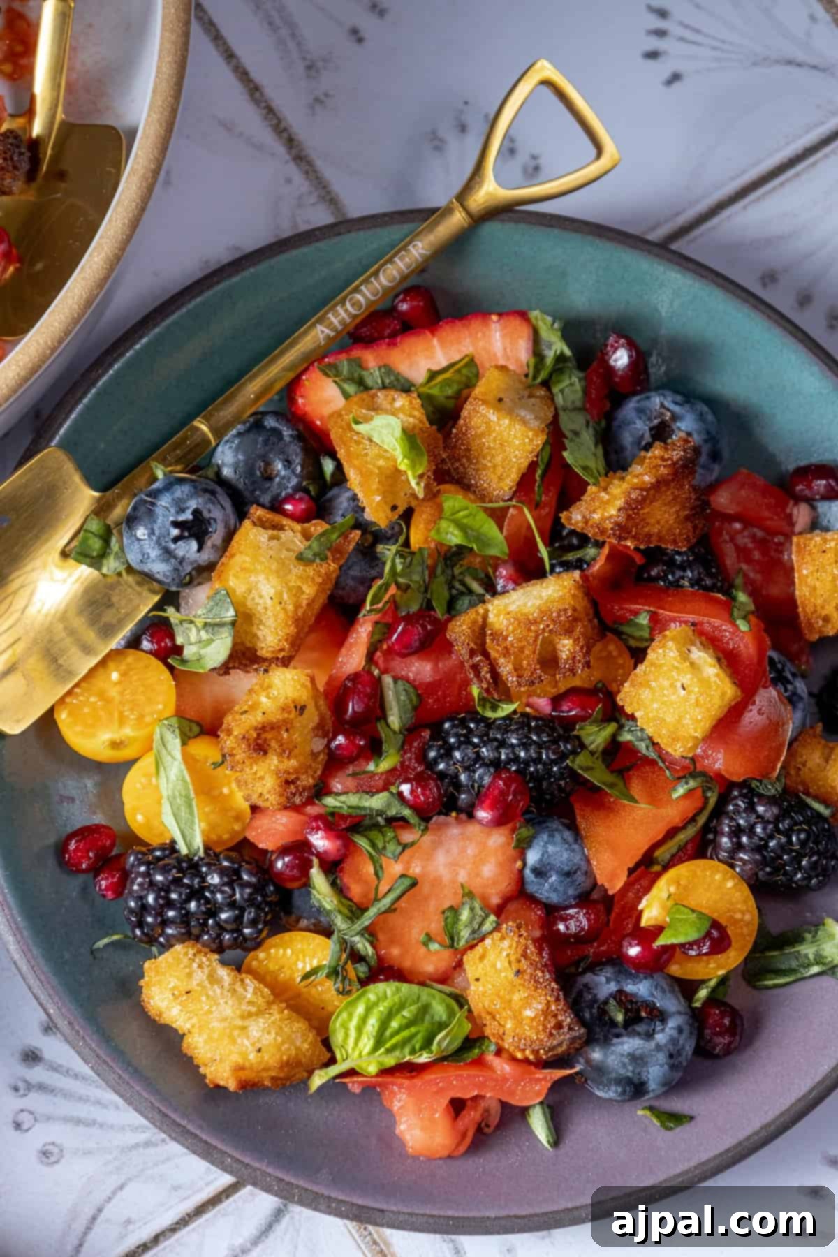 Summer Berry Burrata Medley 8 A beautifully arranged plate of fresh fruit salad featuring a vibrant mix of berries.