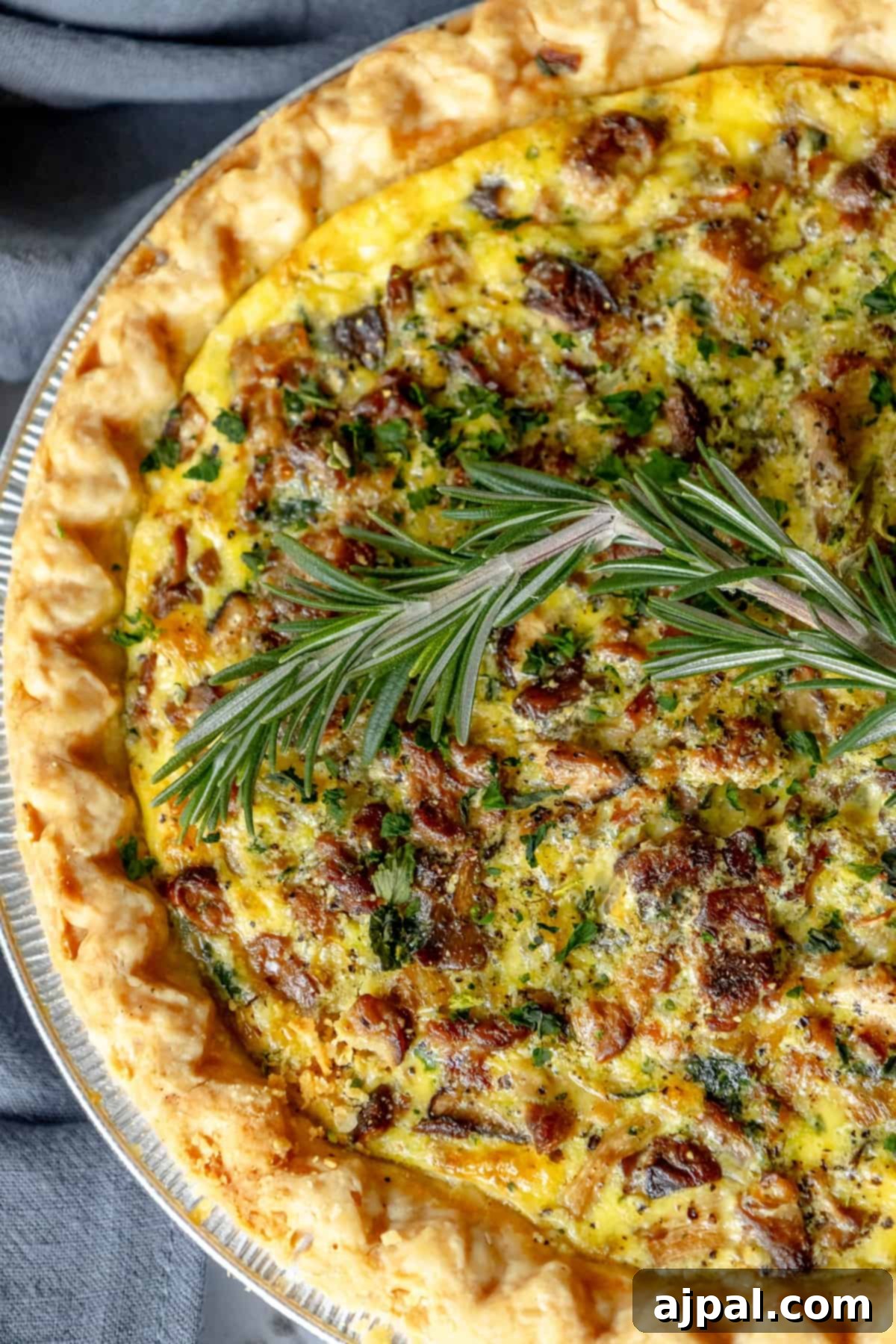 Forest Mushroom Quiche 2 A beautifully baked mushroom quiche, garnished with fresh herbs, ready to be served.