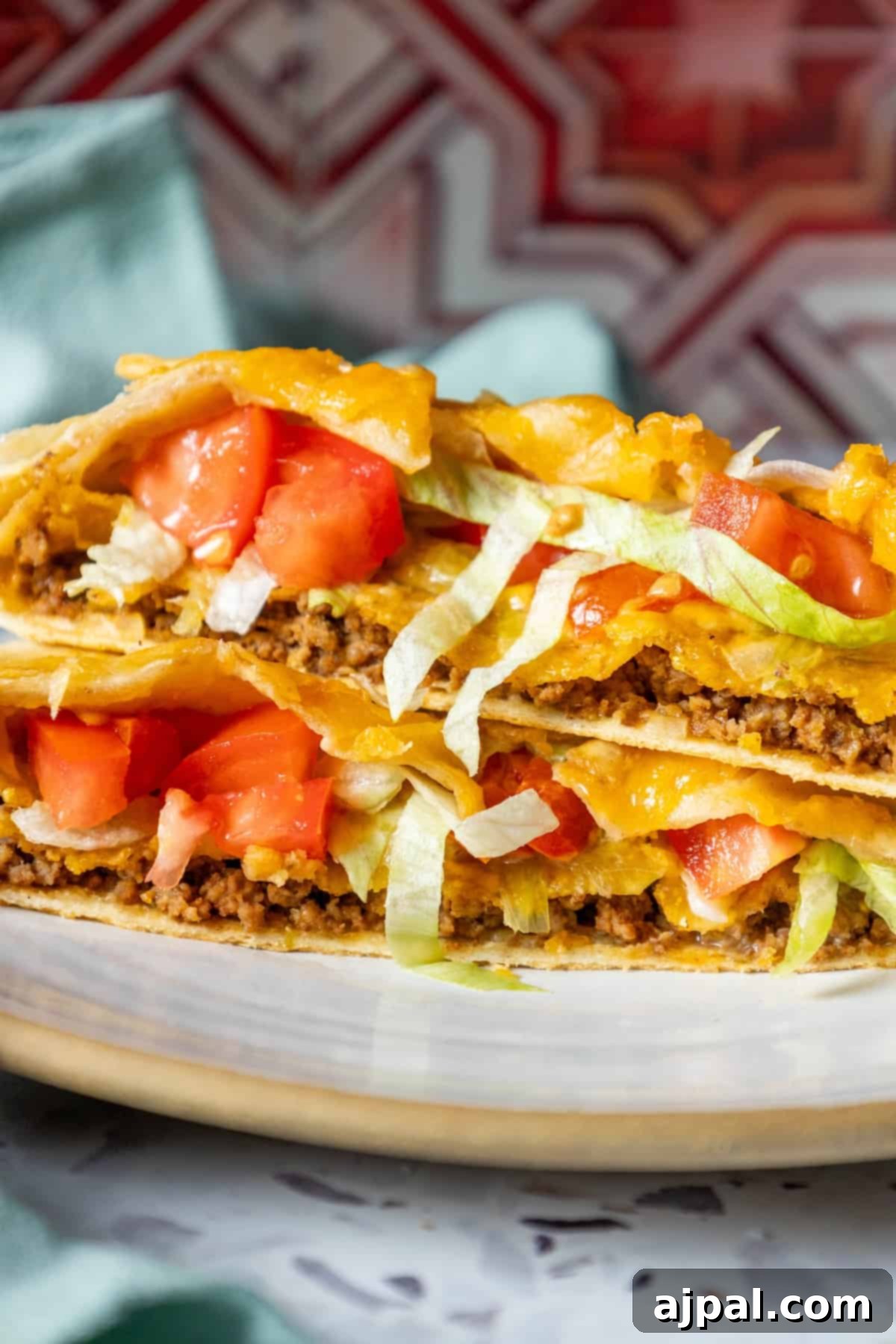 DIY Crunchwrap Delights 12 Two perfectly stacked homemade quesadillas on a pristine white plate, showcasing their golden crusts and inviting fillings.