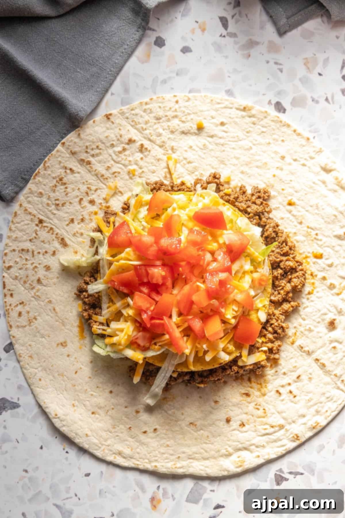 DIY Crunchwrap Delights 9 A homemade burrito filled with a delightful mix of meat and colorful vegetables, showcasing fresh ingredients.