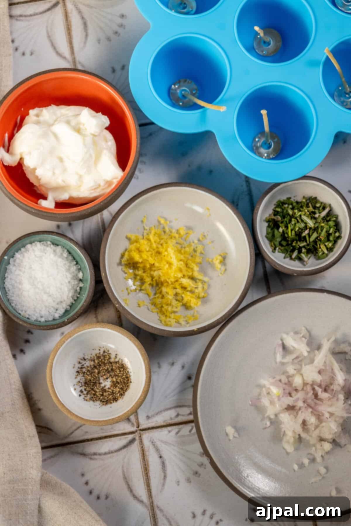 A bowl filled with fresh onions, garlic, and other aromatic ingredients, ready for preparing edible tallow candles.