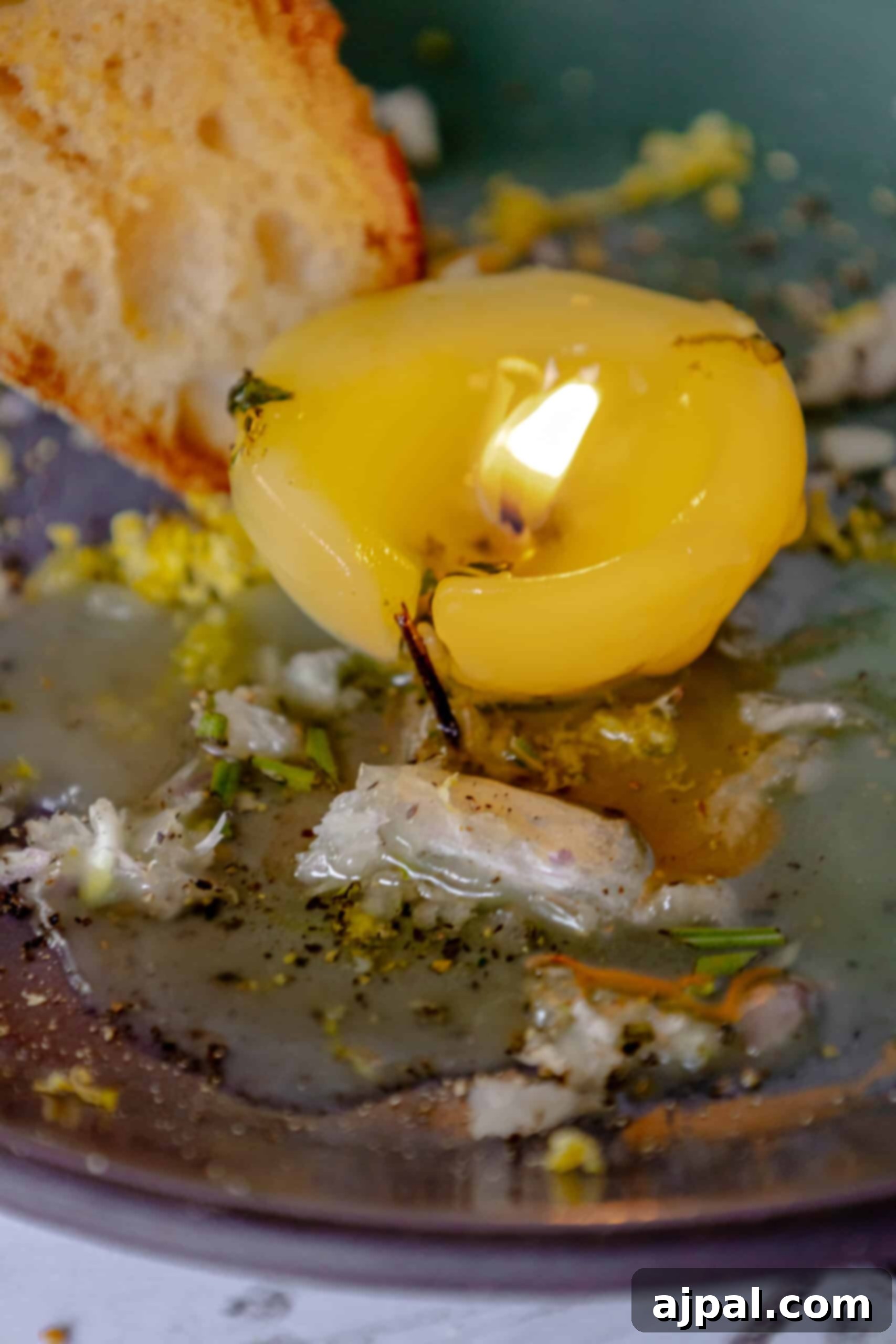 A delectable edible tallow candle presented on a plate, ready to be enjoyed as a savory dip.