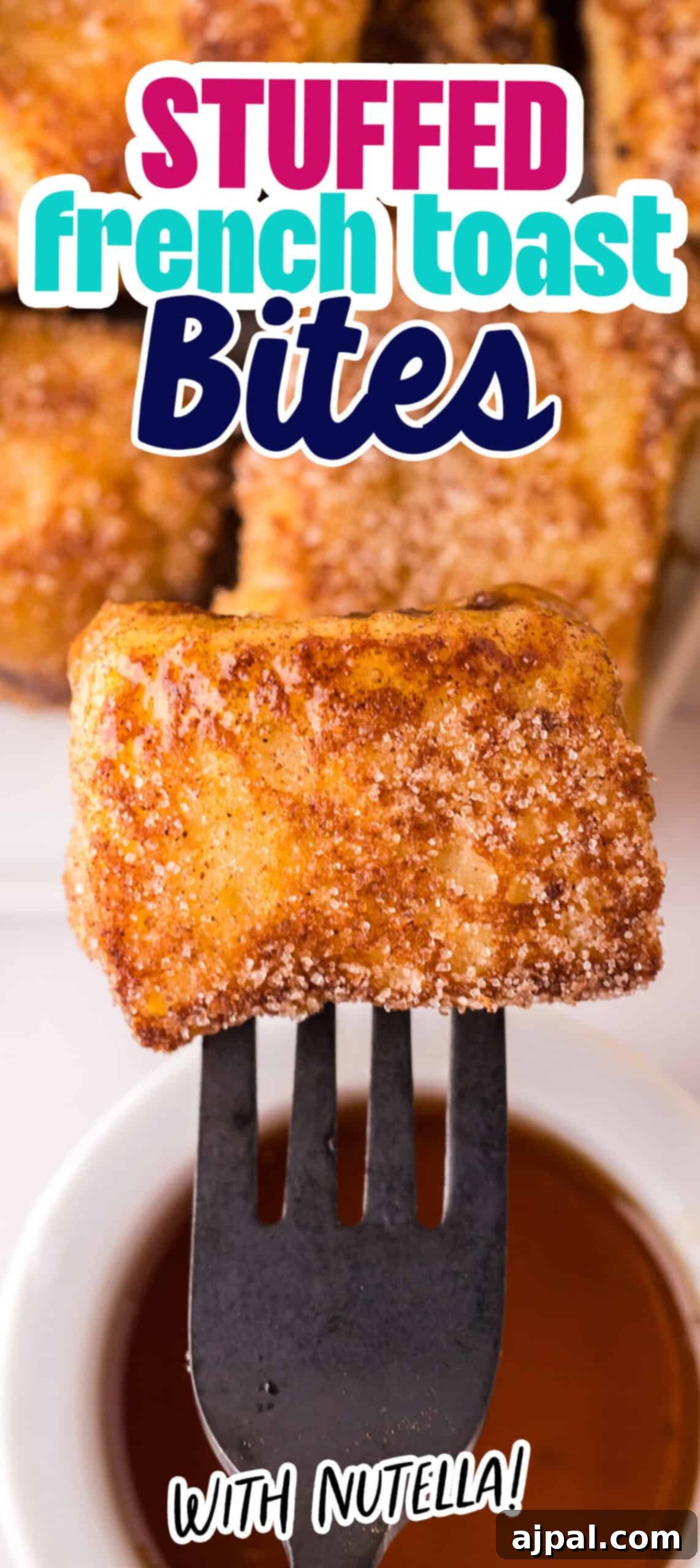 Vertical image of a stack of golden Nutella Stuffed French Toast Bites on a plate, garnished and ready to serve.