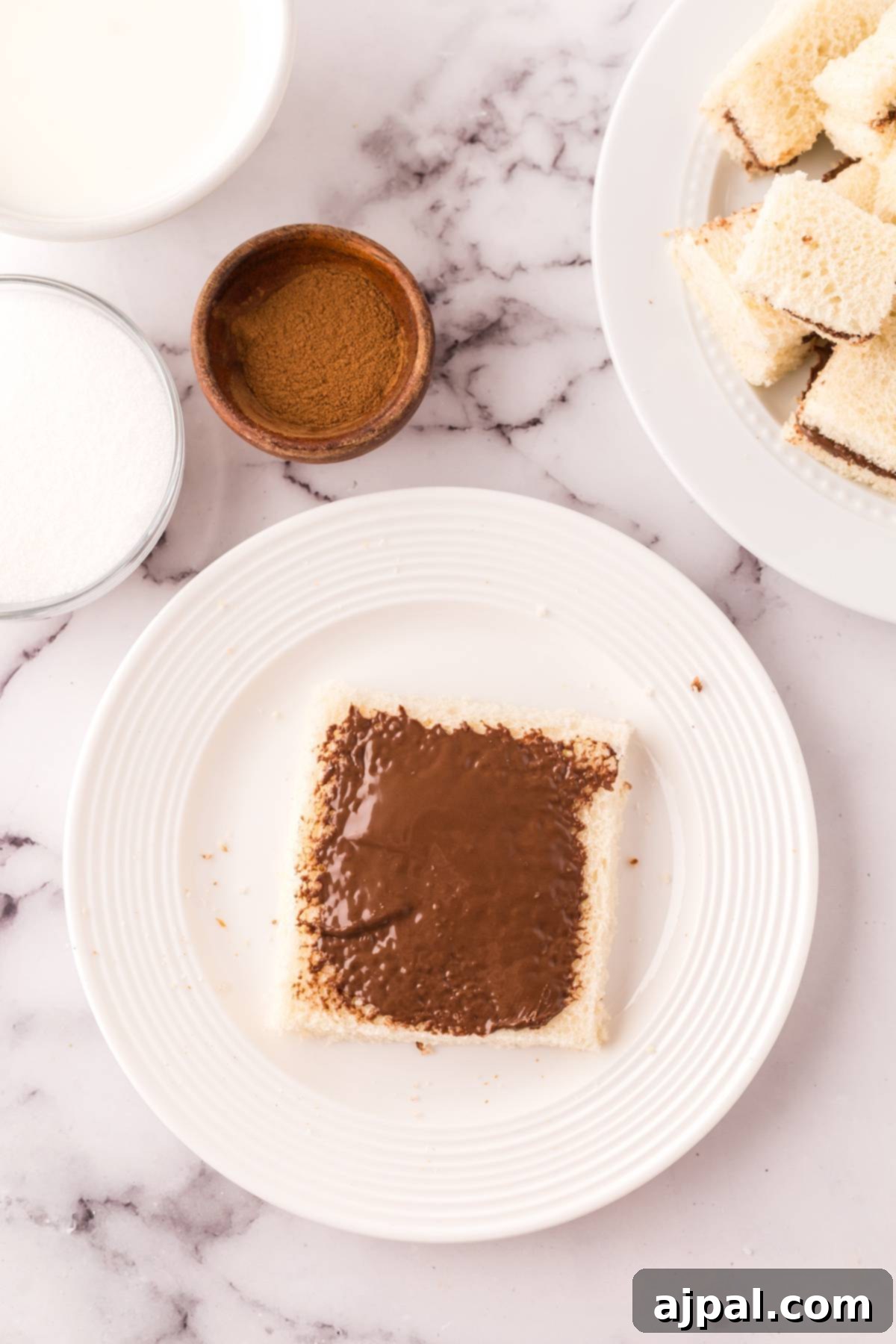 A plate of French Toast bites stuffed with chocolate, ready for cooking.