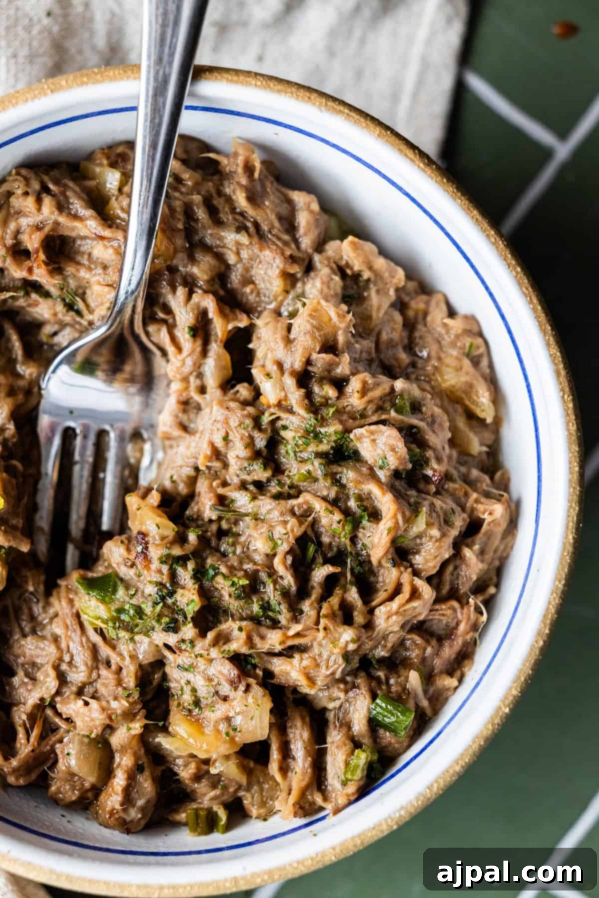 Shredded beef with herbs and vegetables, inspired by Onion Soup Pot Roast.
