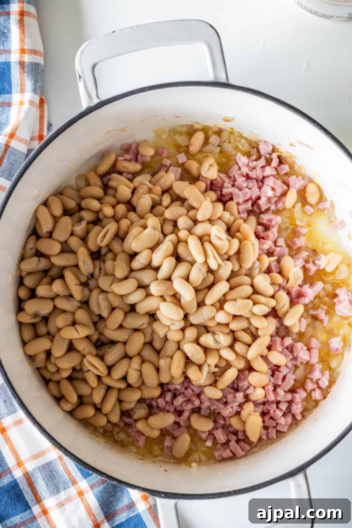 Pot of brothy ham and beans with white beans and ham