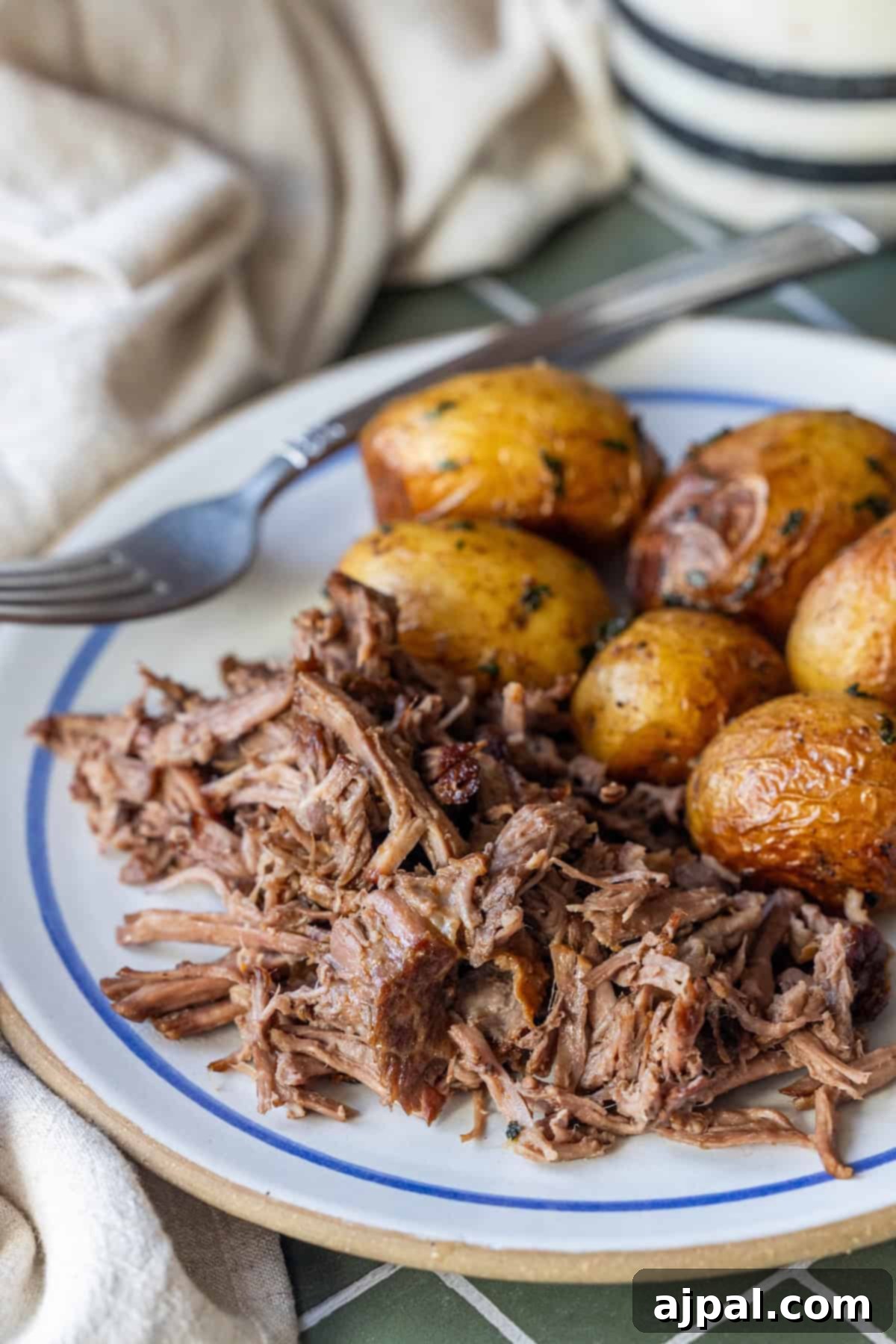 Plate of tender Slow Cooker Chuck Roast and roasted baby potatoes