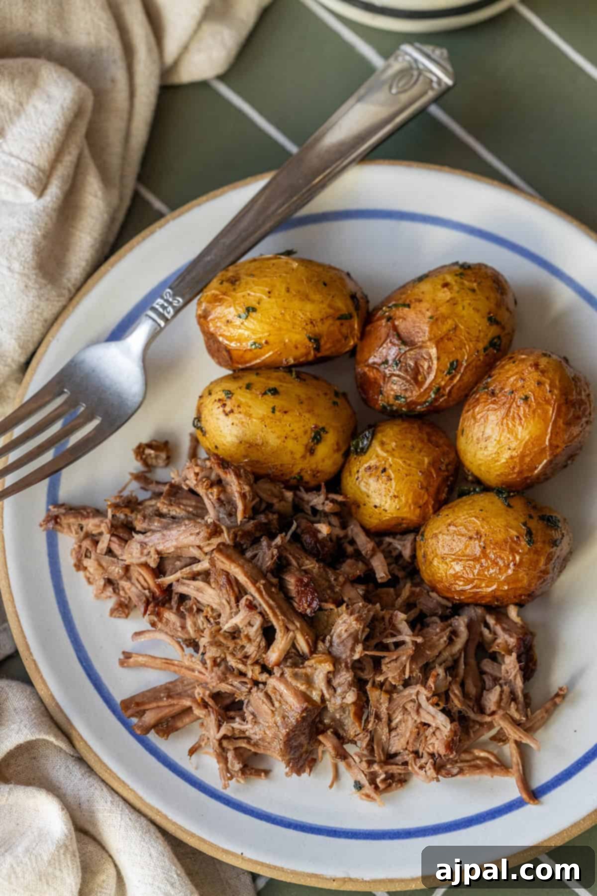 Seasoned roasted baby potatoes and tender shredded Slow Cooker Chuck Roast
