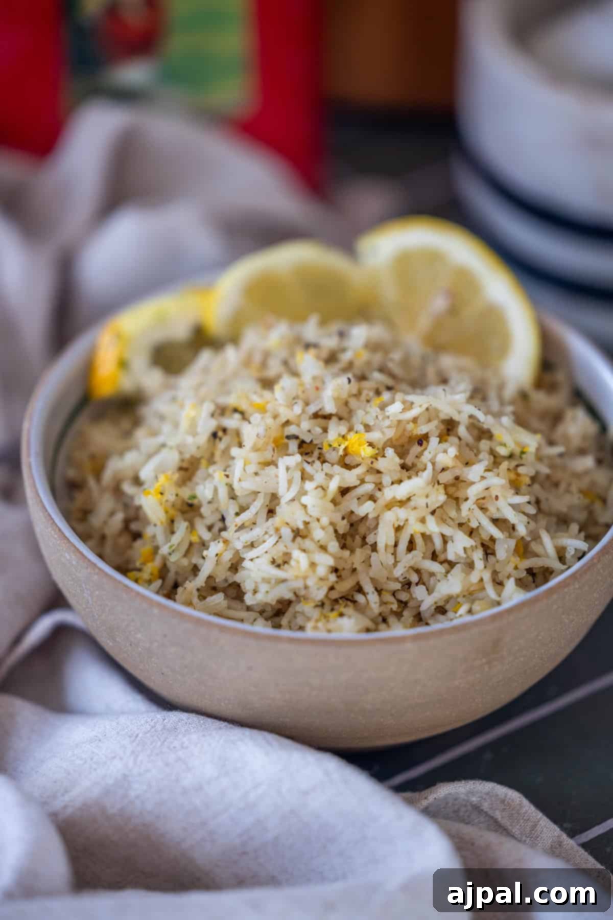 Baked Lemon Rice garnished with lemon slices and herbs.