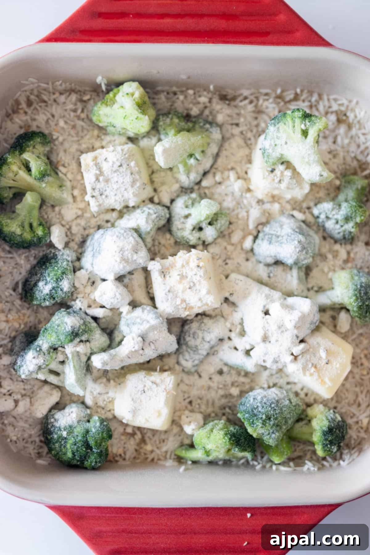 Rice, broccoli, butter, and seasoning in a baking dish