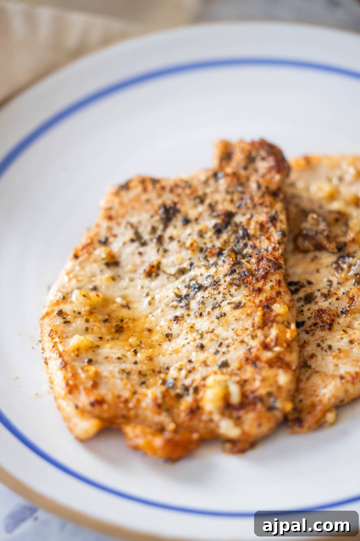 Close-up of pan-seared pork schnitzel with garlic