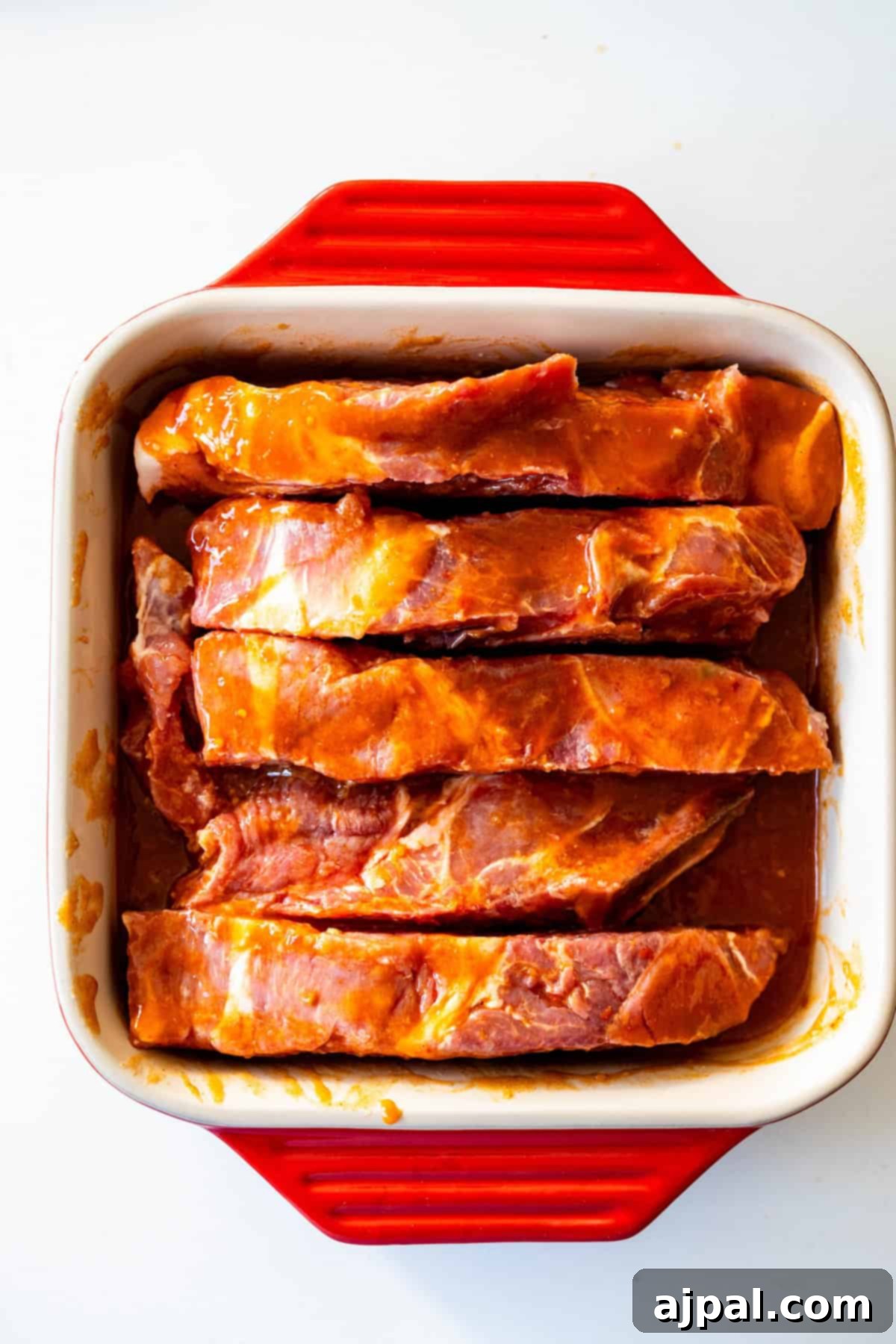 Raw country style ribs coated in marinade.