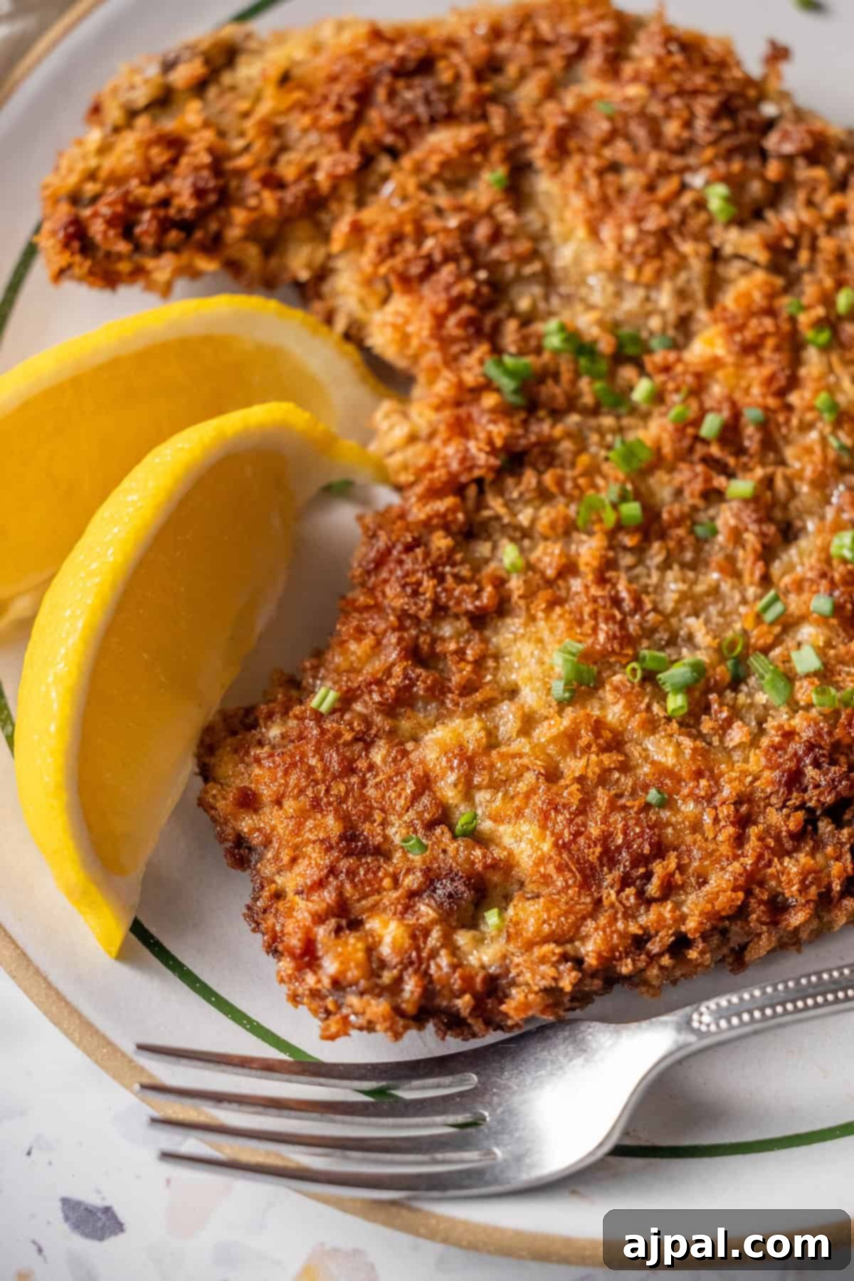 Crispy Beef Milanesa served with lemon wedges