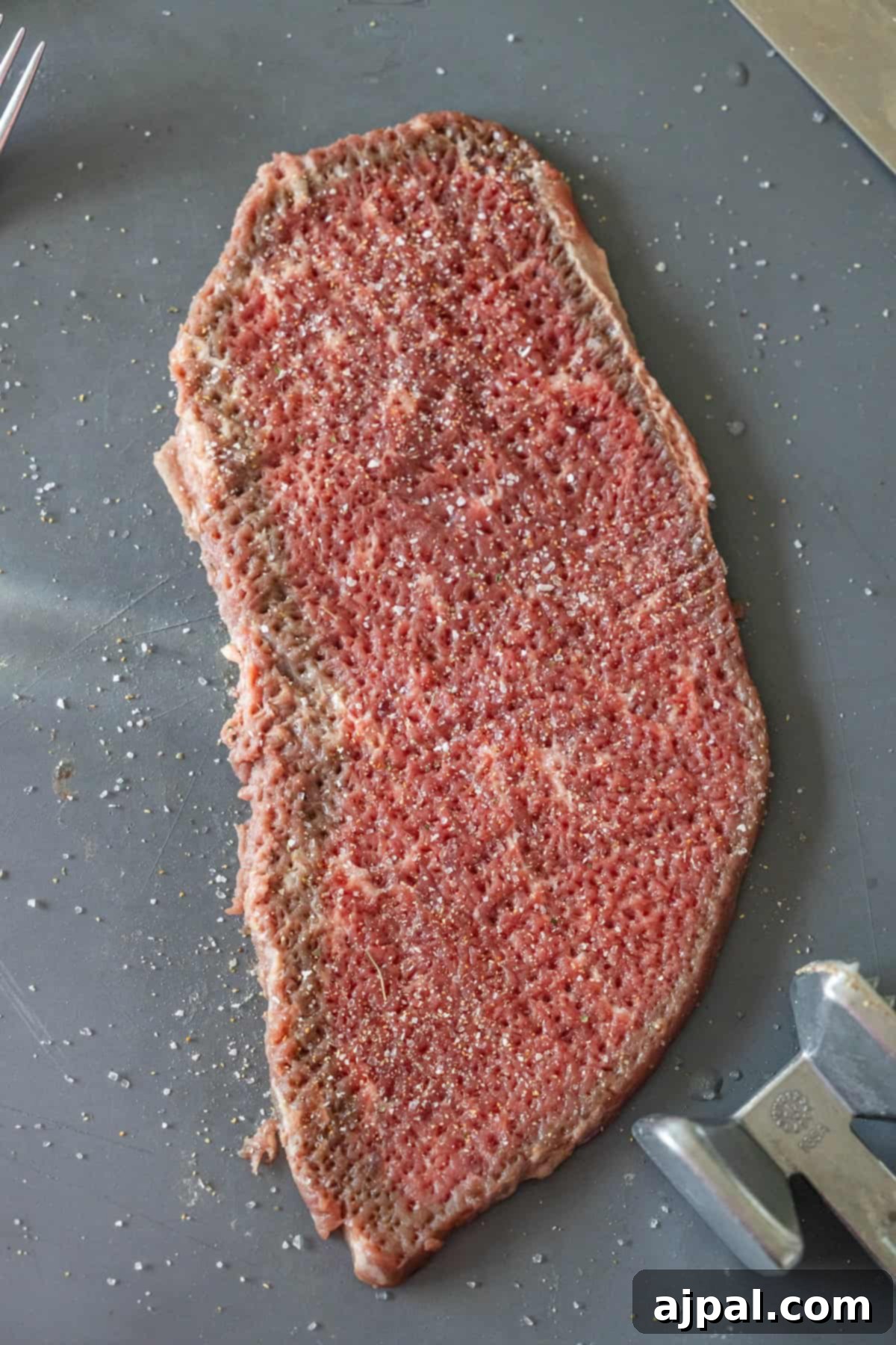 Raw steak with salt and pepper